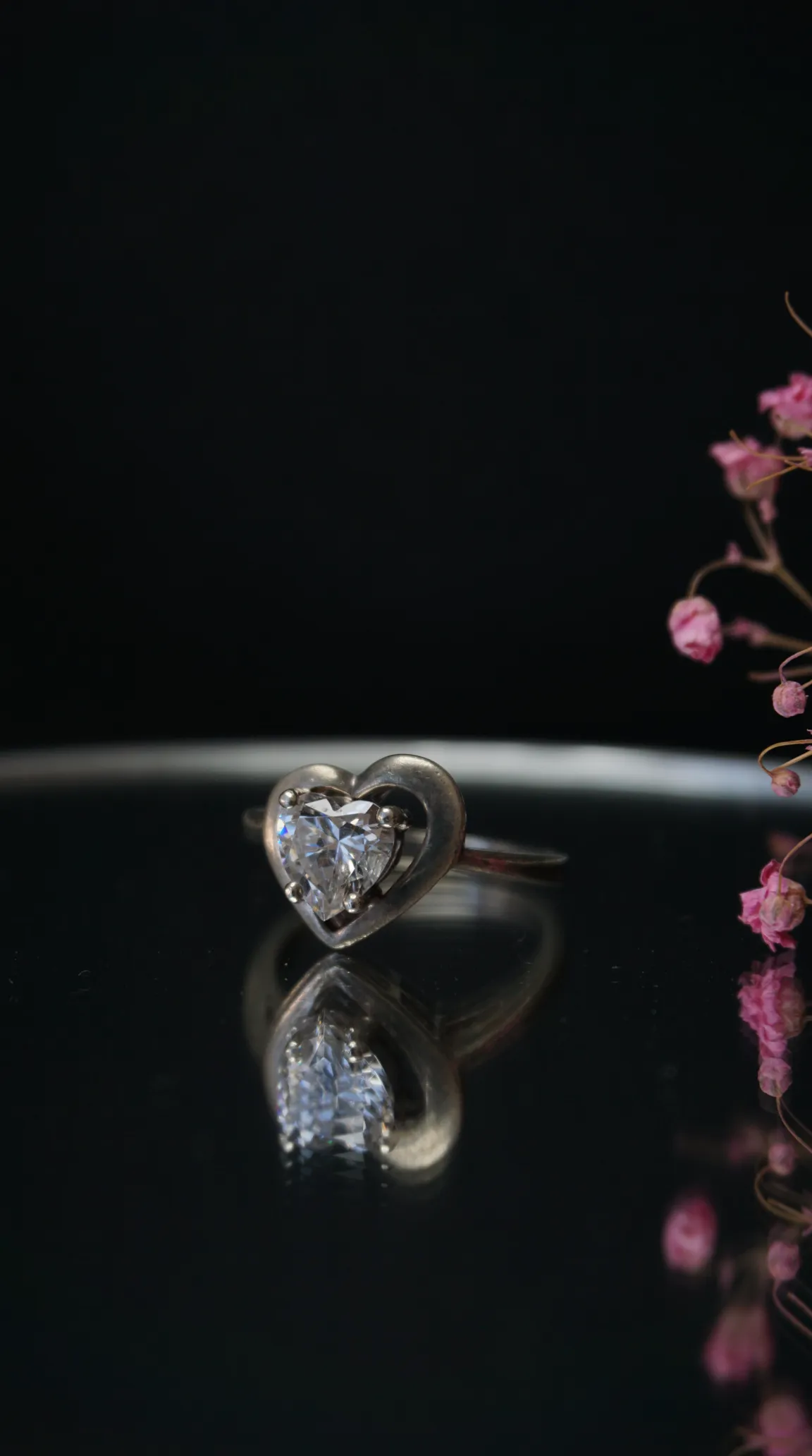 Vintage sterling silver heart ring with brilliant clear gemstone, elegant antique jewelry for women.