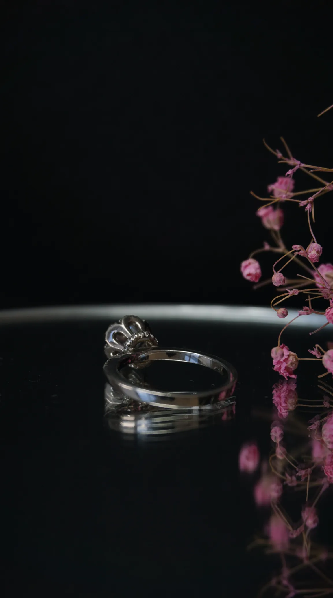 Vintage silver ring with intricate crown setting and pink floral accents
