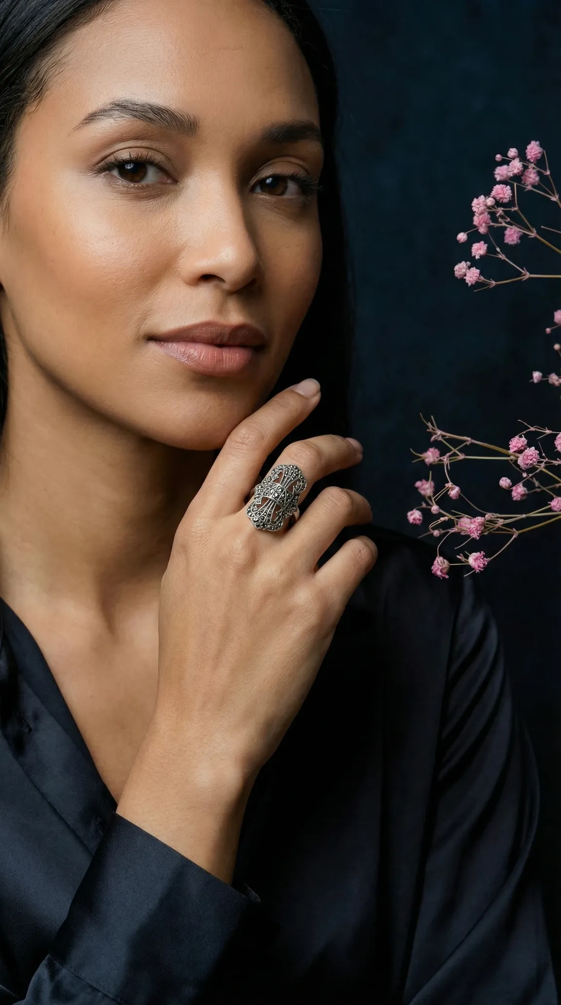 Vintage Art Deco style silver marcasite filigree cocktail ring modeled on a woman's hand.