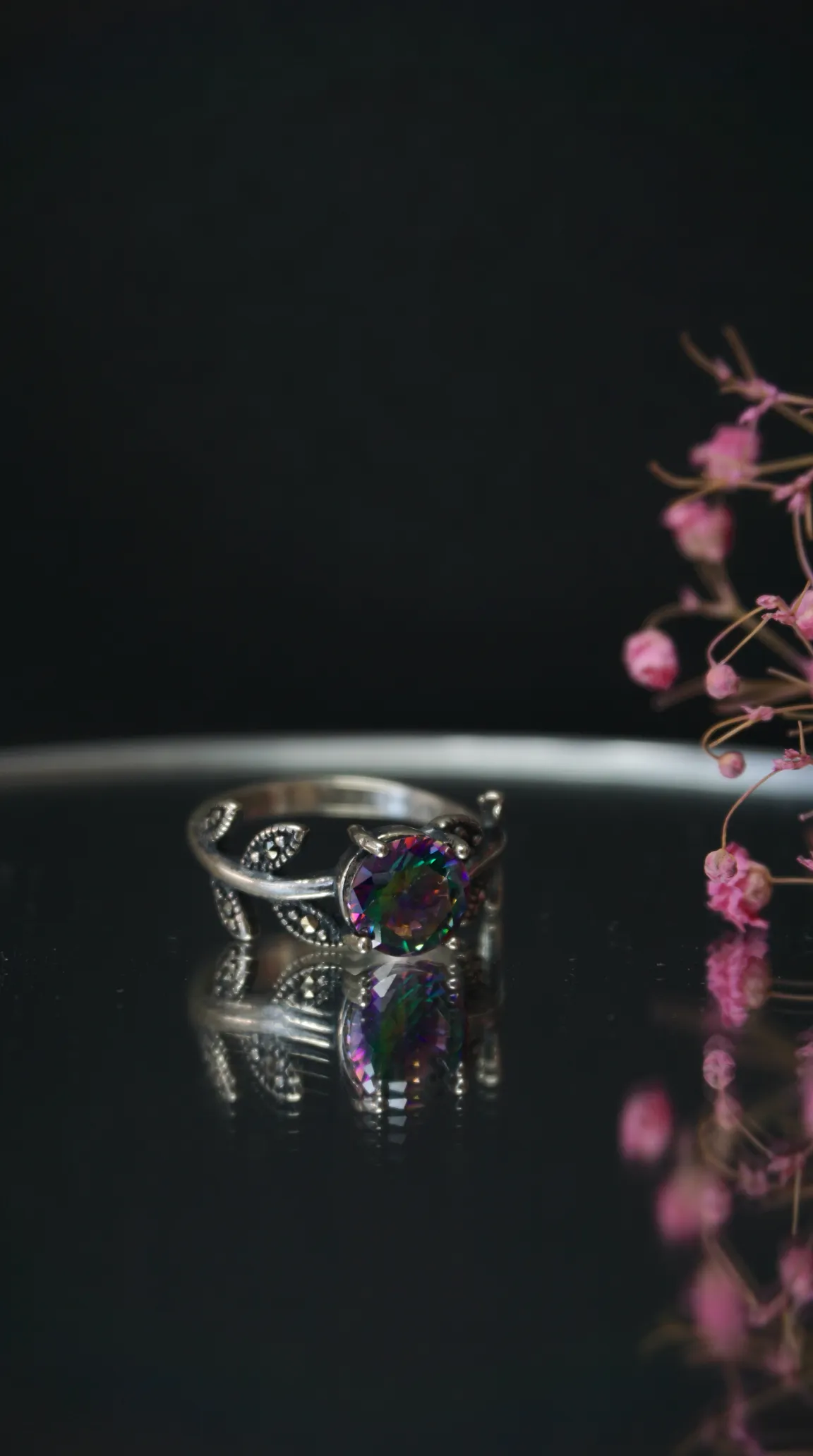 Vintage sterling silver ring with rainbow mystic topaz and marcasite leaf design.