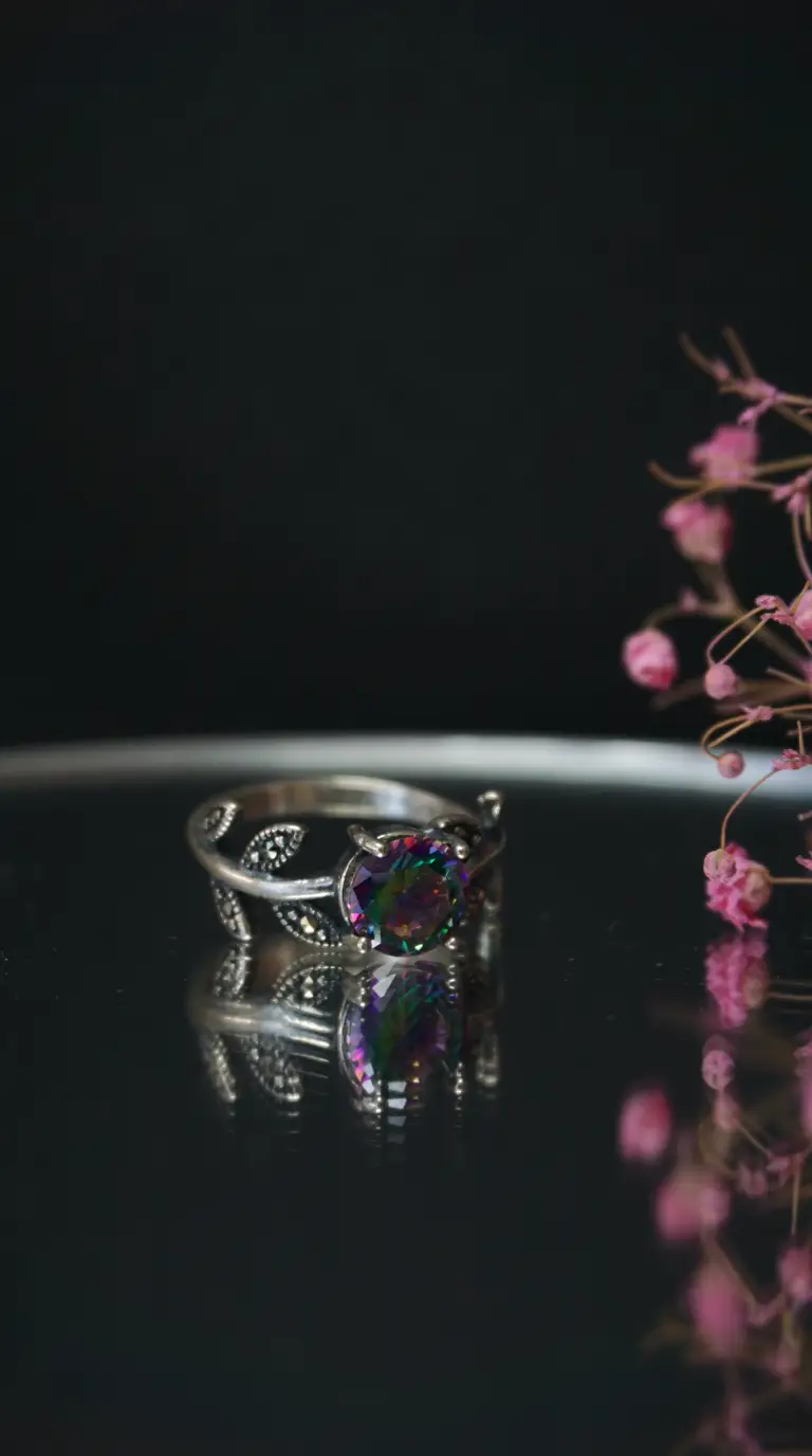 Vintage sterling silver ring with rainbow mystic topaz and marcasite leaf design.