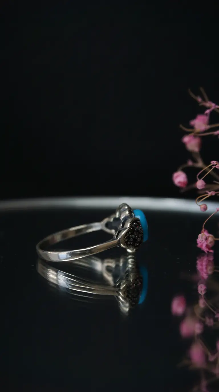 Vintage sterling silver ring with blue turquoise stone and black marcasite accents.