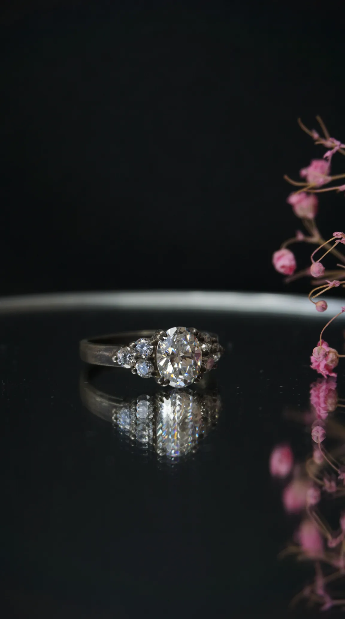 Vintage diamond engagement ring with sparkling center stone and accent diamonds in an antique silver setting.