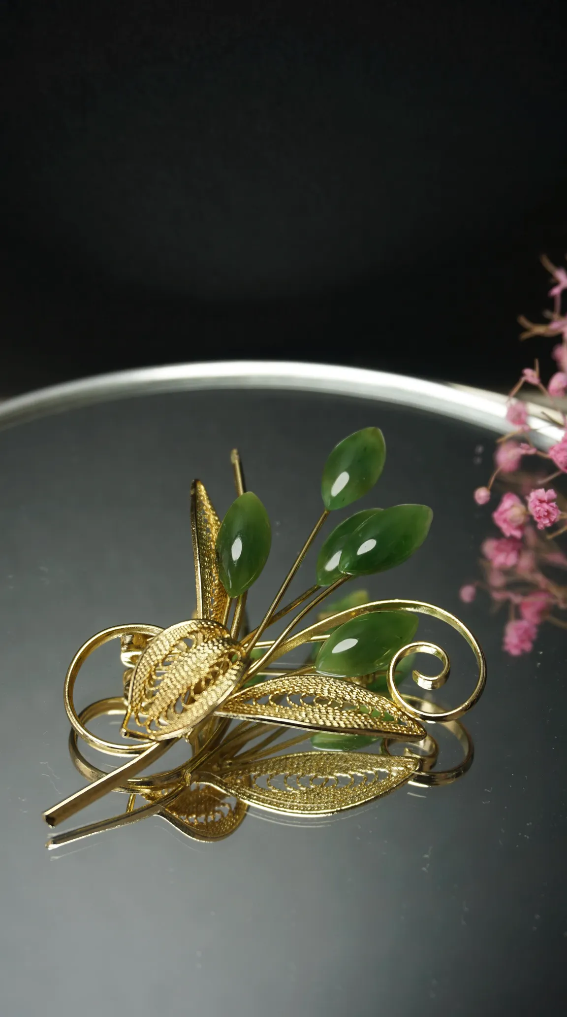 Vintage gold filigree brooch with green jade leaf accents