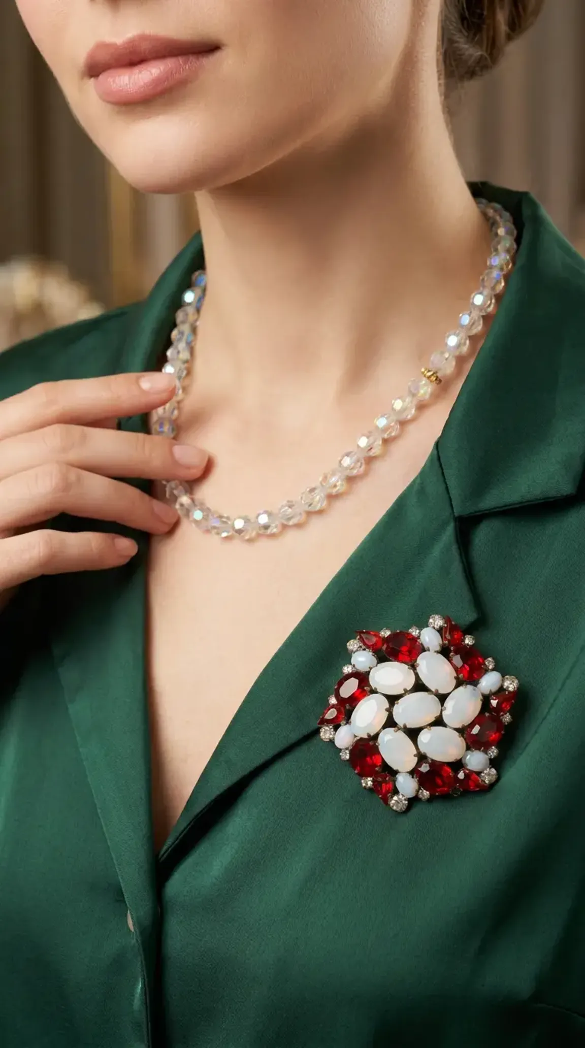 Vintage statement necklace with red and white cabochon stones, clear rhinestone accents, and faceted crystal bead chain, elegantly displayed on a model wearing a black v-neck dress.