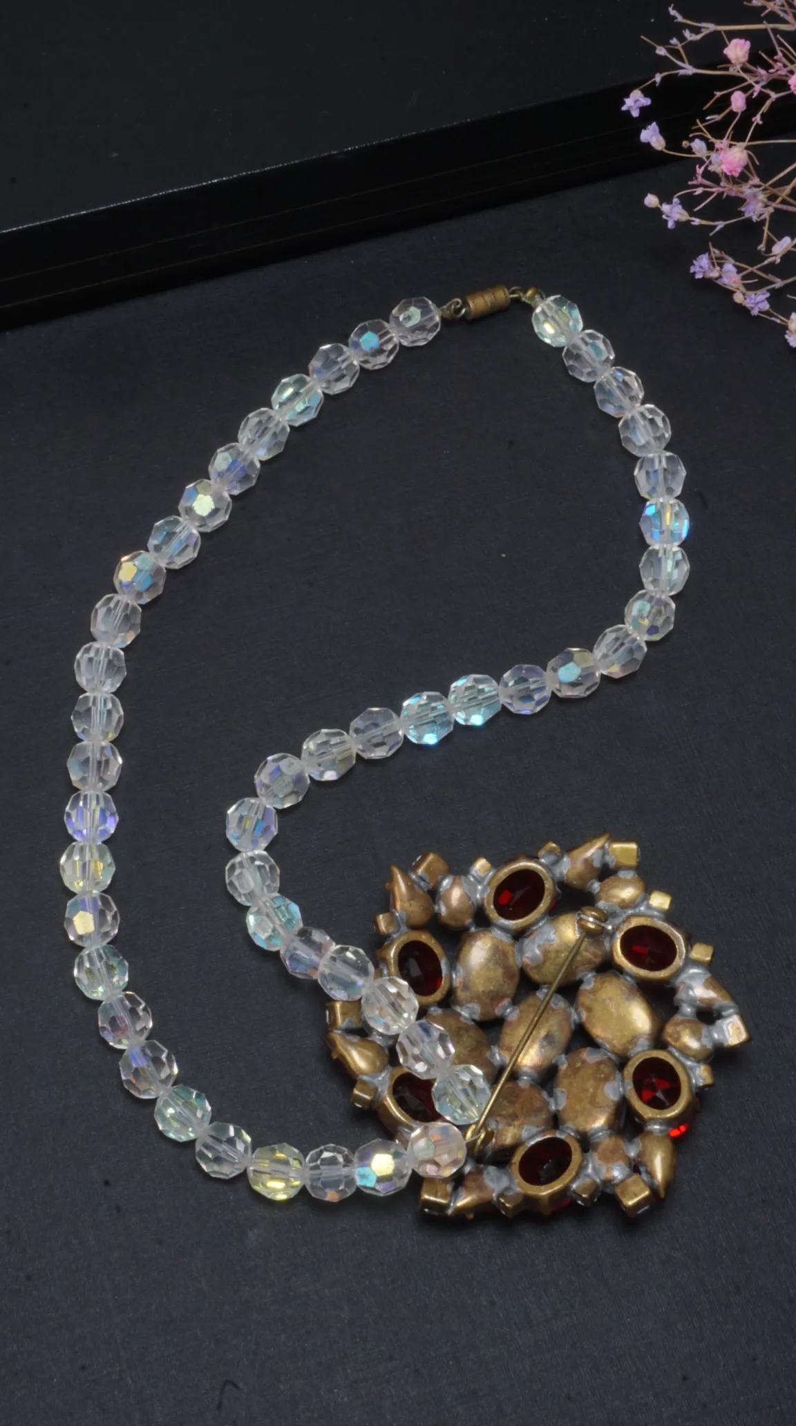 Vintage faceted Aurora Borealis crystal bead necklace with antique gold-tone red rhinestone brooch