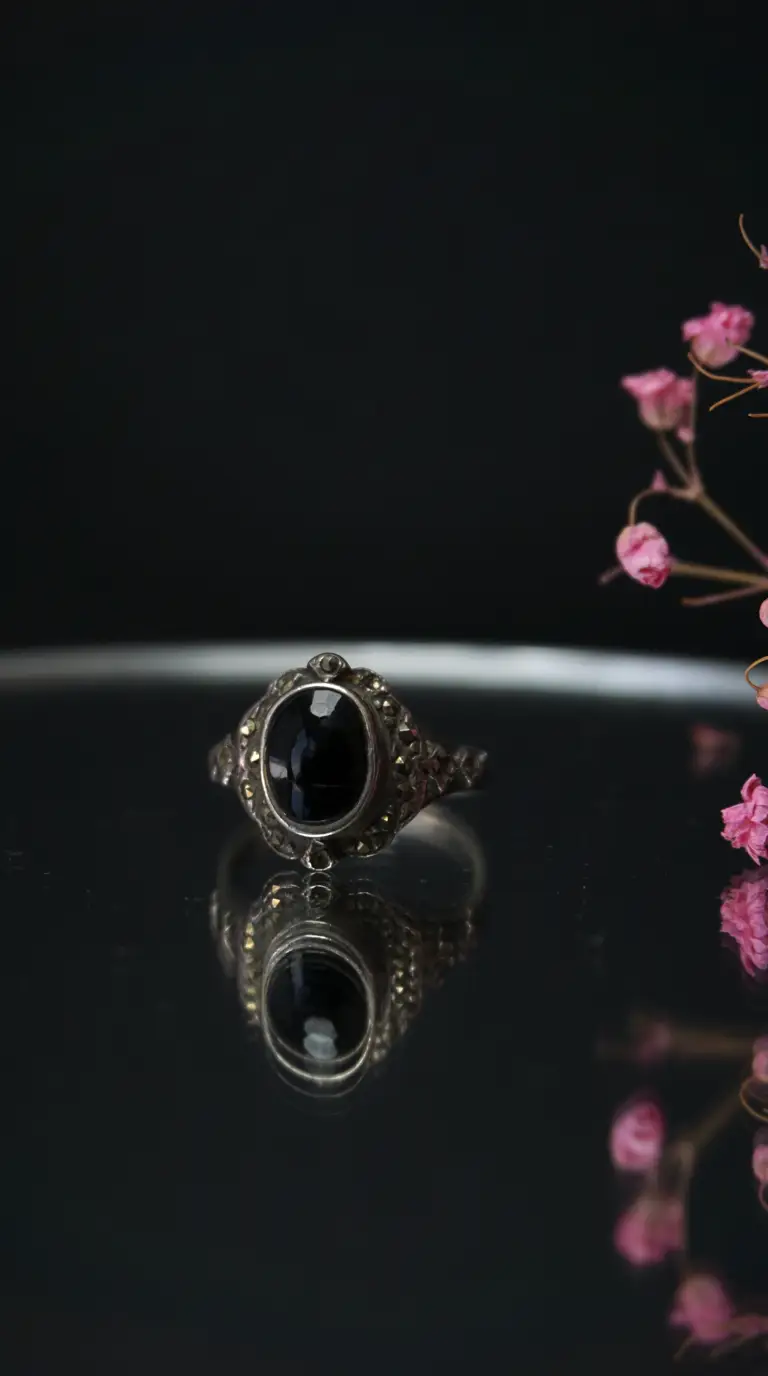 Vintage sterling silver ring with oval black onyx gemstone and marcasite detail
