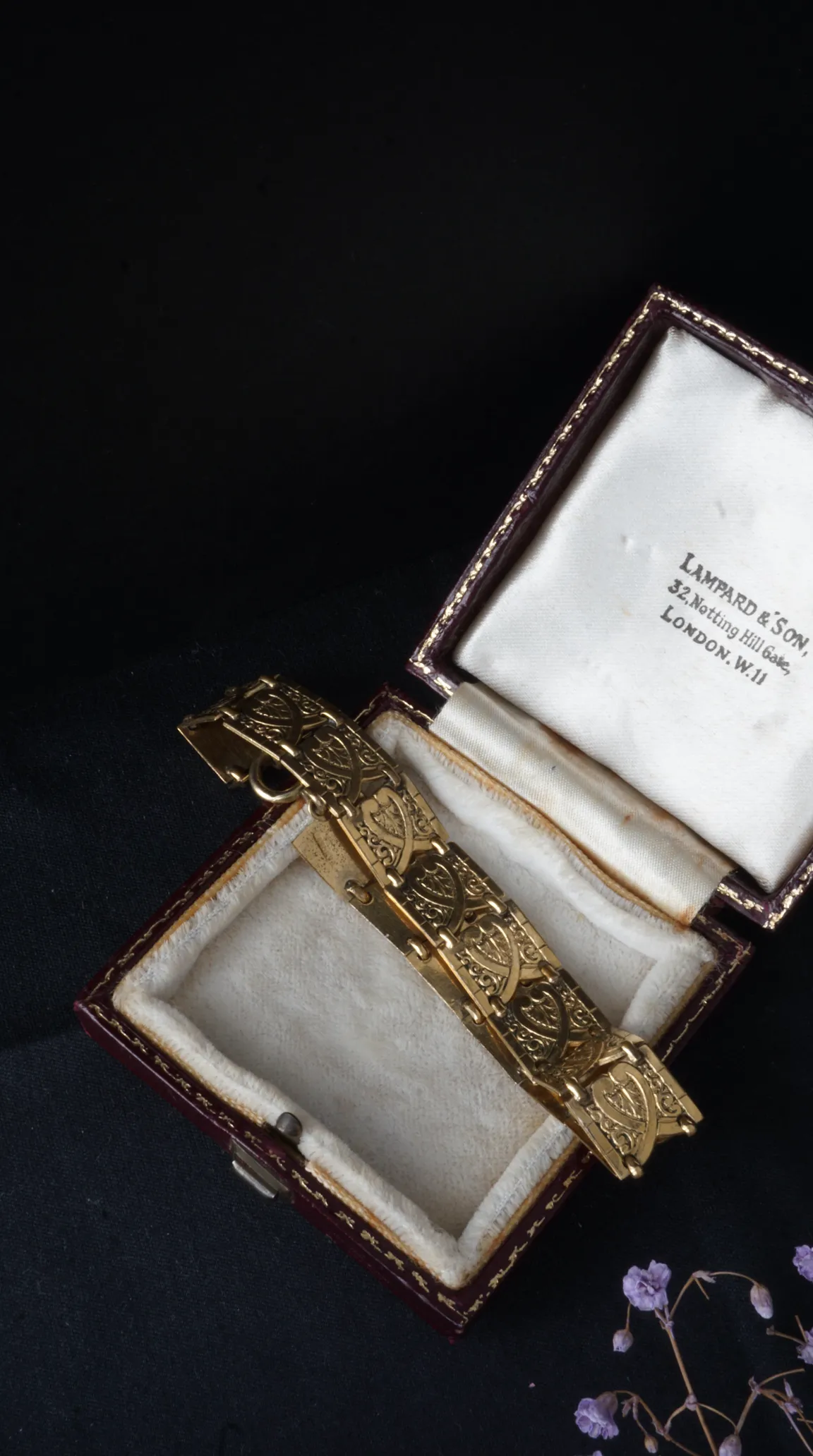 Vintage gold ornate bracelet with intricate Celtic pattern, displayed in an antique Lampard & Son Notting Hill Gate London jewelry box.