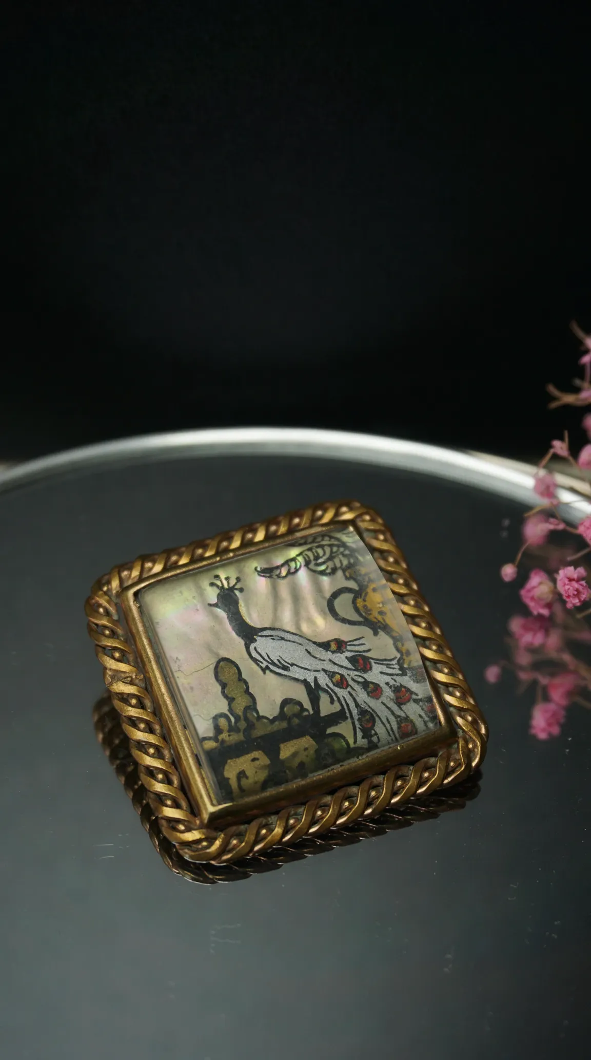 Vintage peacock mother of pearl brooch with twisted gold-tone frame