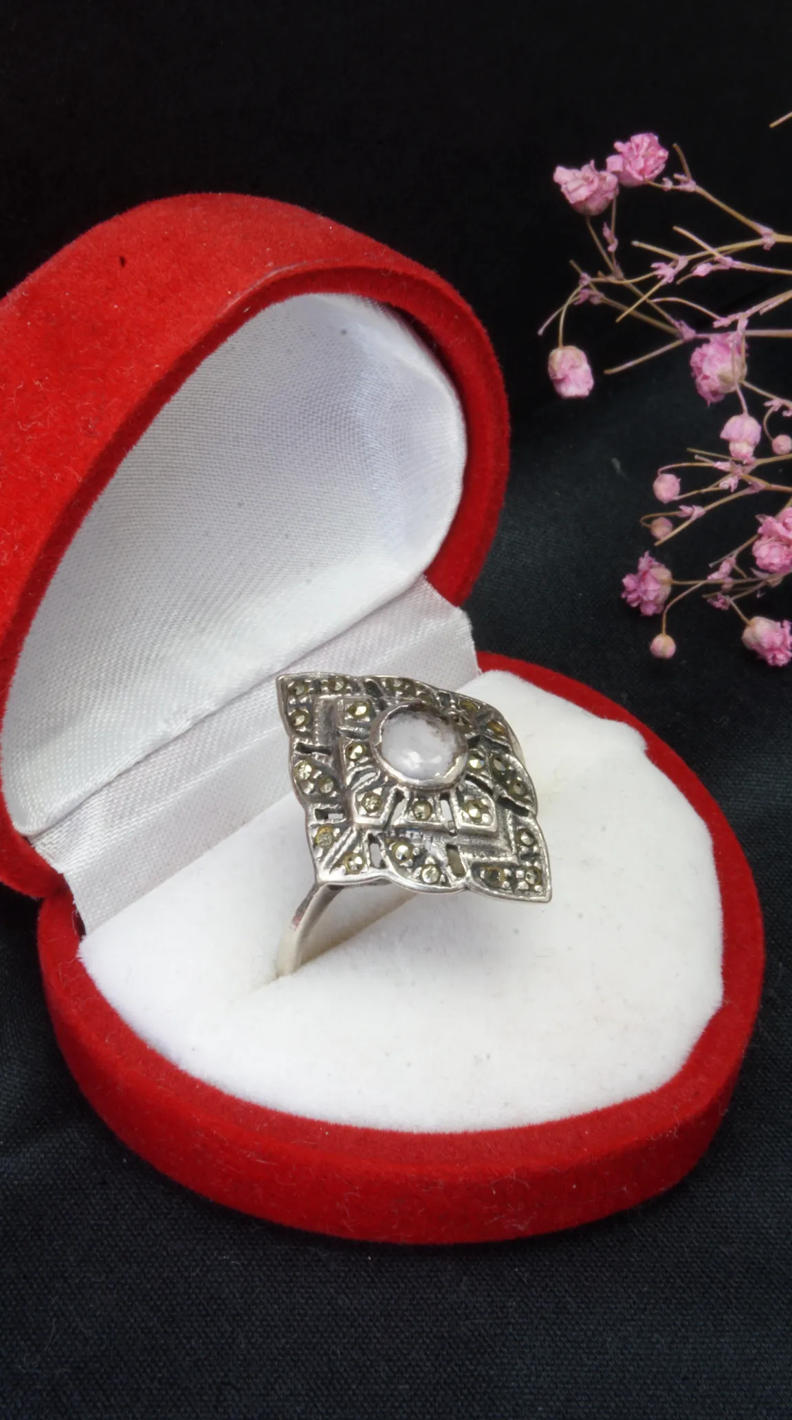 Vintage silver marcasite ring with a white stone in a red velvet heart-shaped jewelry box