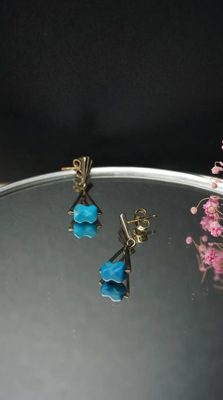 Vintage gold geometric dangle earrings with vibrant blue carved turquoise stones