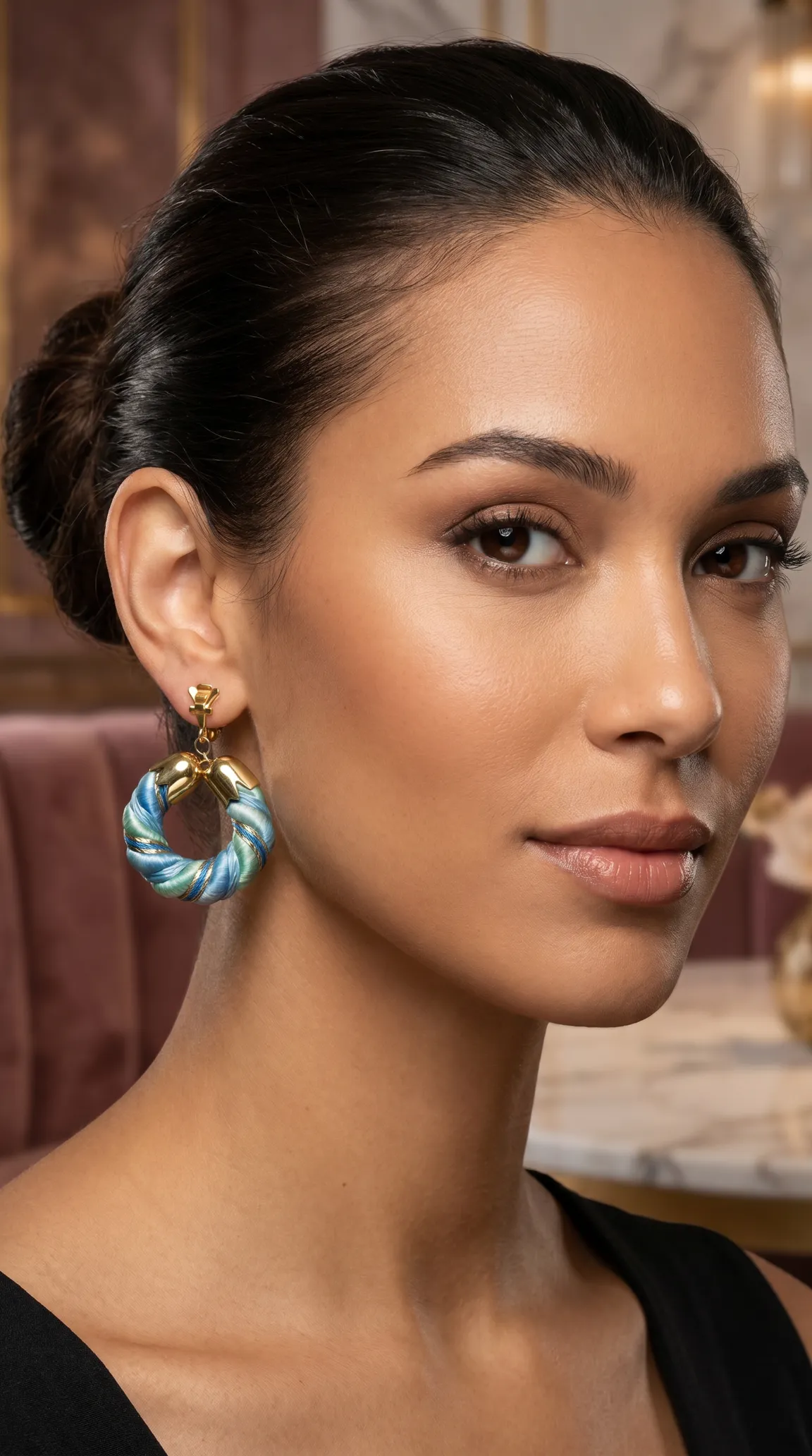 Vintage blue and green twisted cord clip-on hoop earrings with gold accents, modeled by a woman.