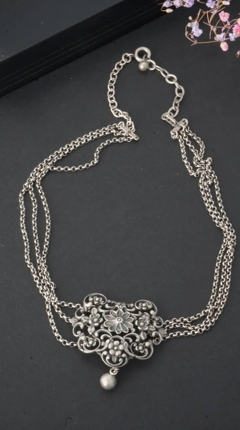 Vintage antique silver multi-strand necklace with ornate floral filigree centerpiece.