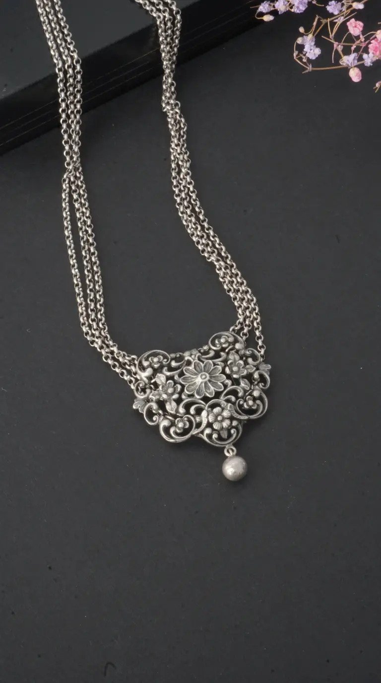 Vintage oxidized silver floral pendant necklace with multiple chains and dangling bead, handcrafted antique jewelry for women.