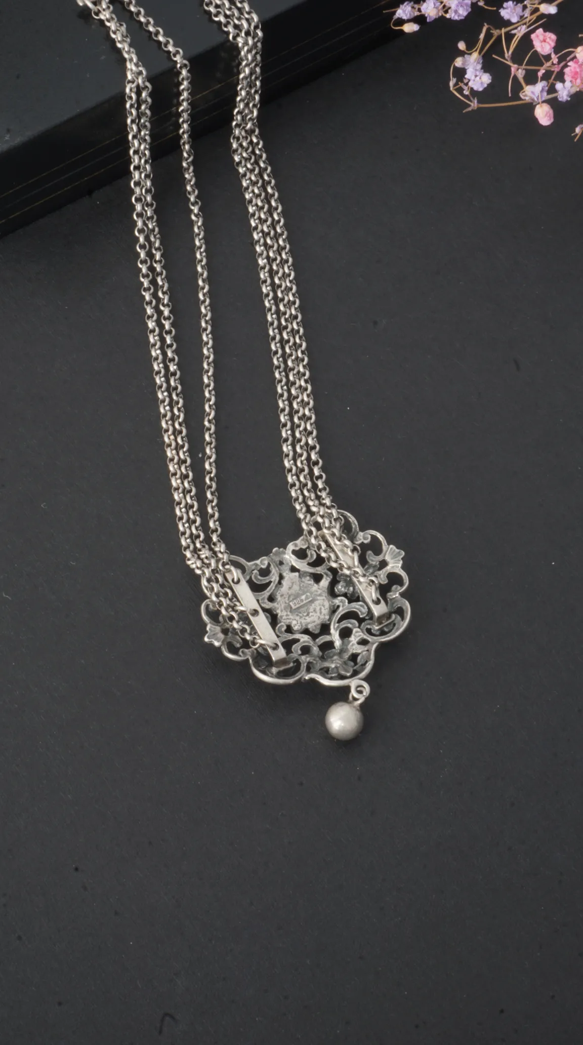 Vintage sterling silver multi-chain necklace with ornate filigree pendant, 925 stamp, and dangling silver bead.