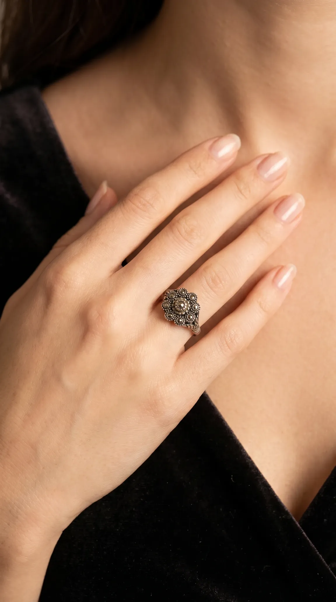 Vintage silver marcasite floral cluster ring on a woman's hand