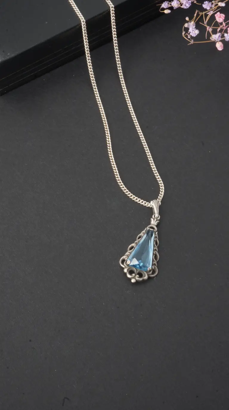 Vintage sterling silver necklace with ornate filigree triangular blue gemstone pendant