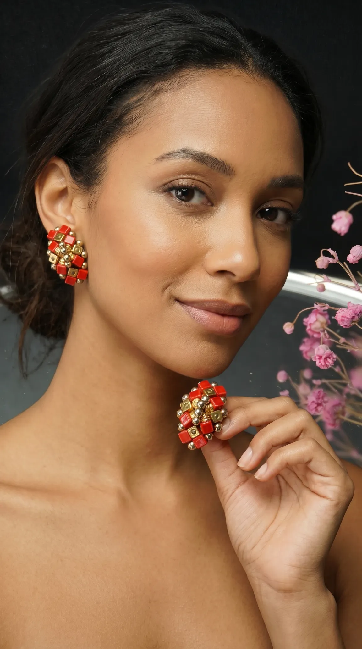 Vintage red and gold cube cluster earrings on a smiling model, with one earring held in hand.