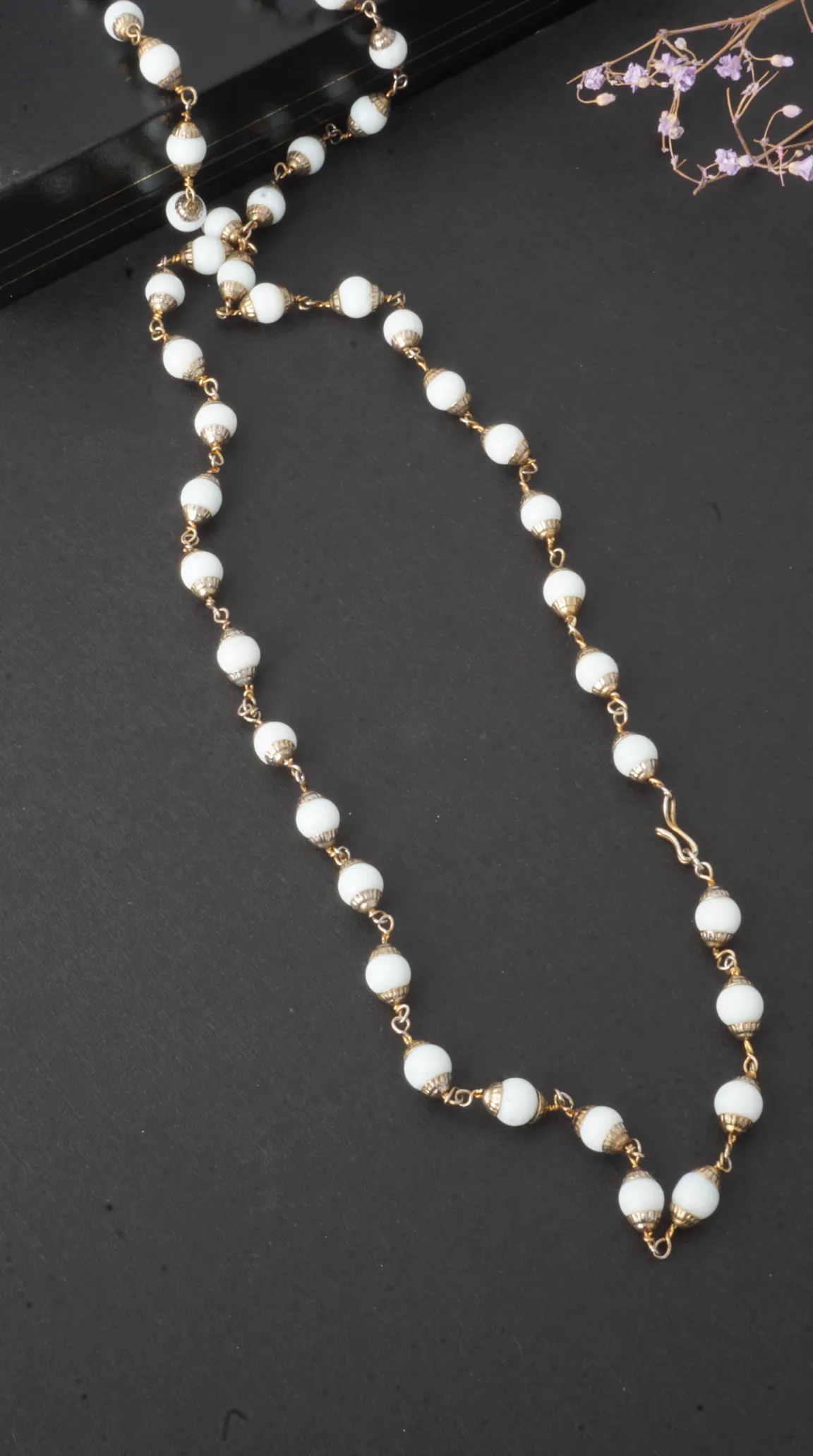 Vintage white opaque bead necklace with gold-tone links, caps, and S-hook clasp.