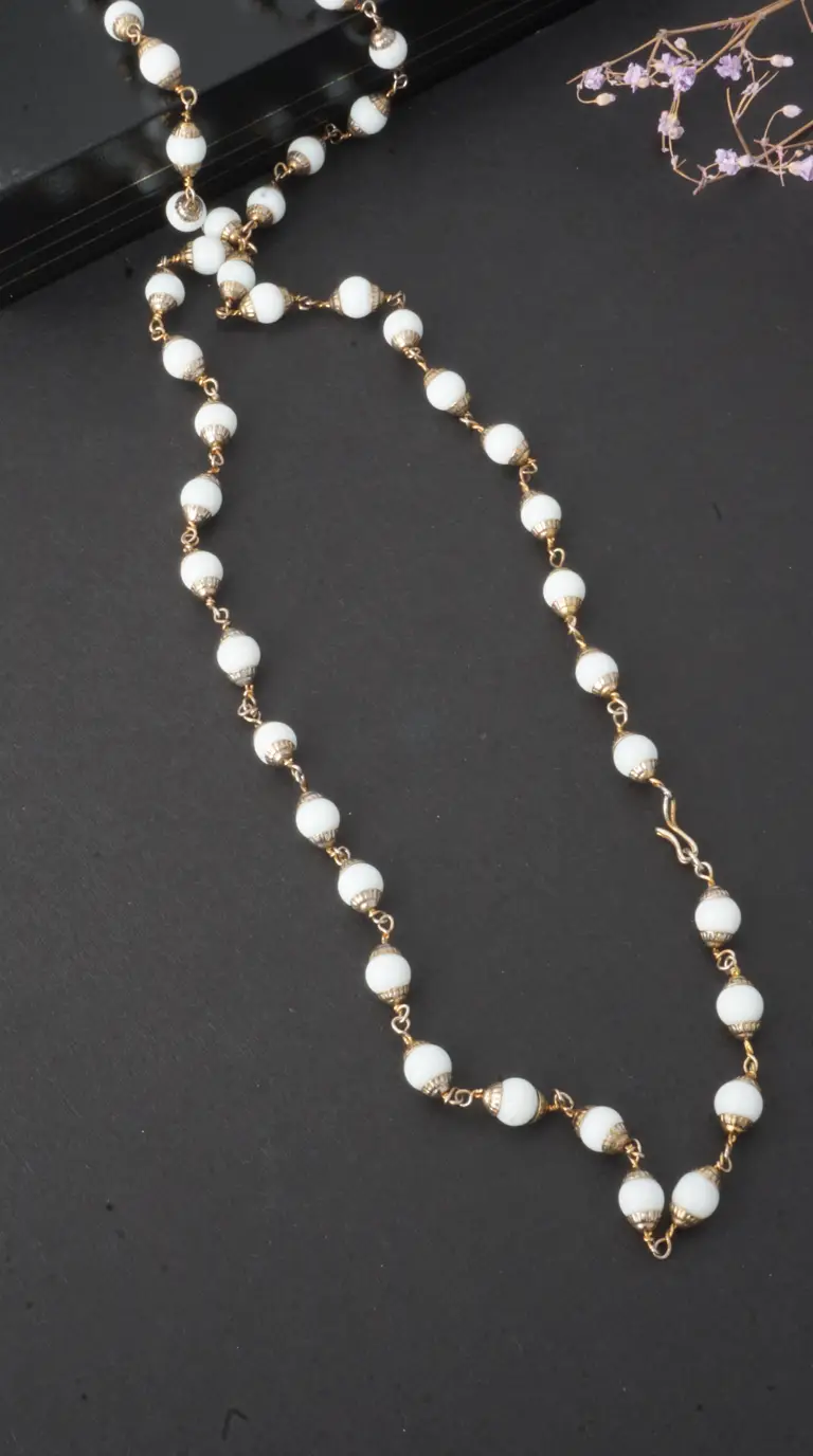 Vintage white opaque bead necklace with gold-tone links, caps, and S-hook clasp.