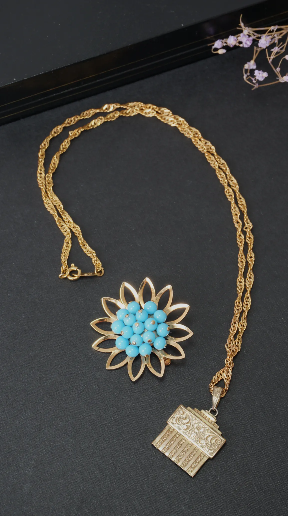 Vintage gold necklace with ornate engraved pendant and floral gold brooch with turquoise blue beads, vintage jewelry.