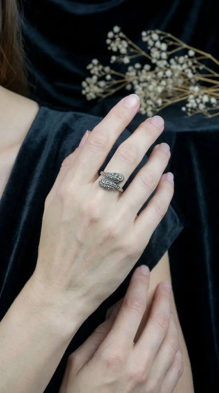 Vintage silver marcasite wrap ring on a woman's hand, antique jewelry.