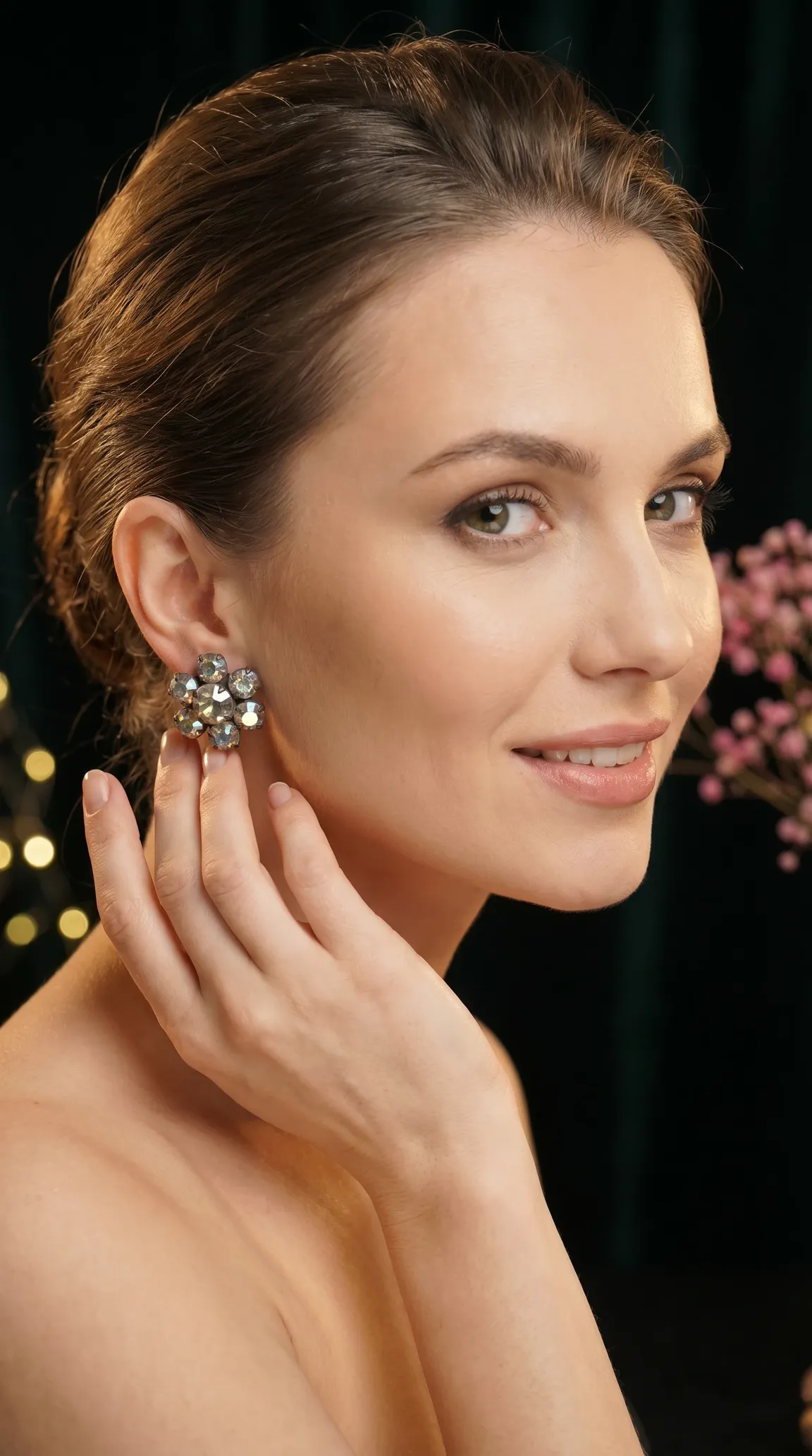 Vintage sparkling rhinestone flower cluster earrings on a woman's ear.