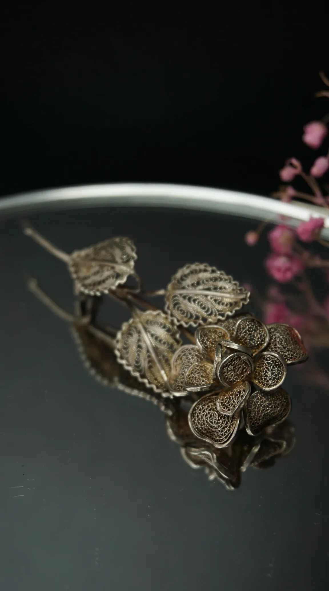 Vintage silver filigree floral brooch with intricate flower and leaves