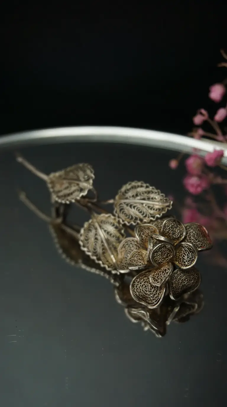Vintage silver filigree floral brooch with intricate flower and leaves
