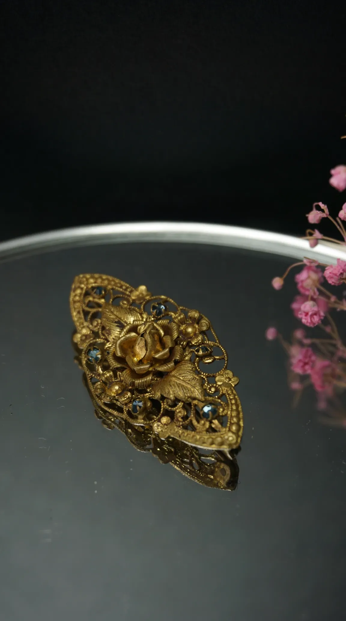 Vintage gold tone floral rose brooch with blue gems, ornate filigree design, vintage jewelry pin.
