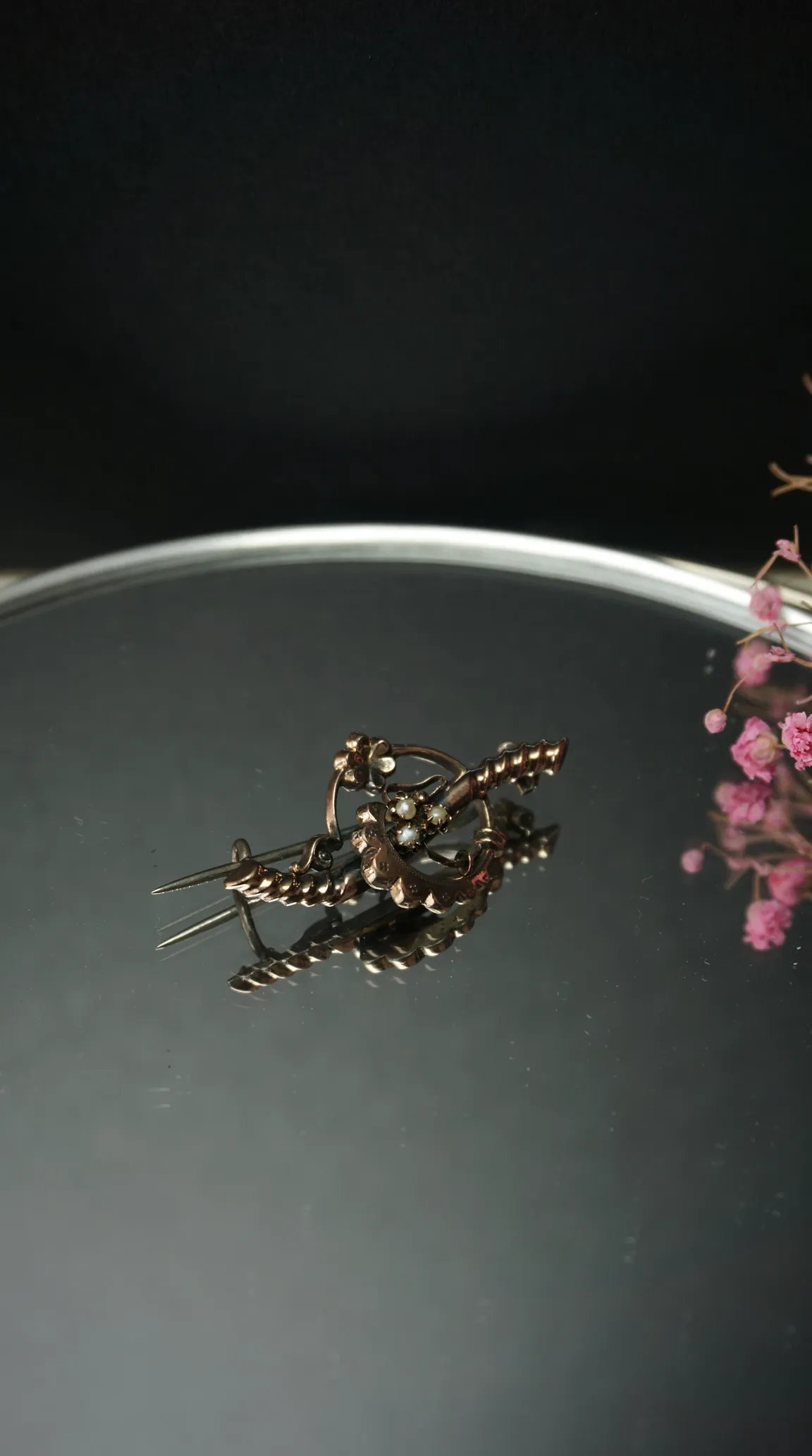 Vintage gold floral brooch with seed pearls on mirrored tray