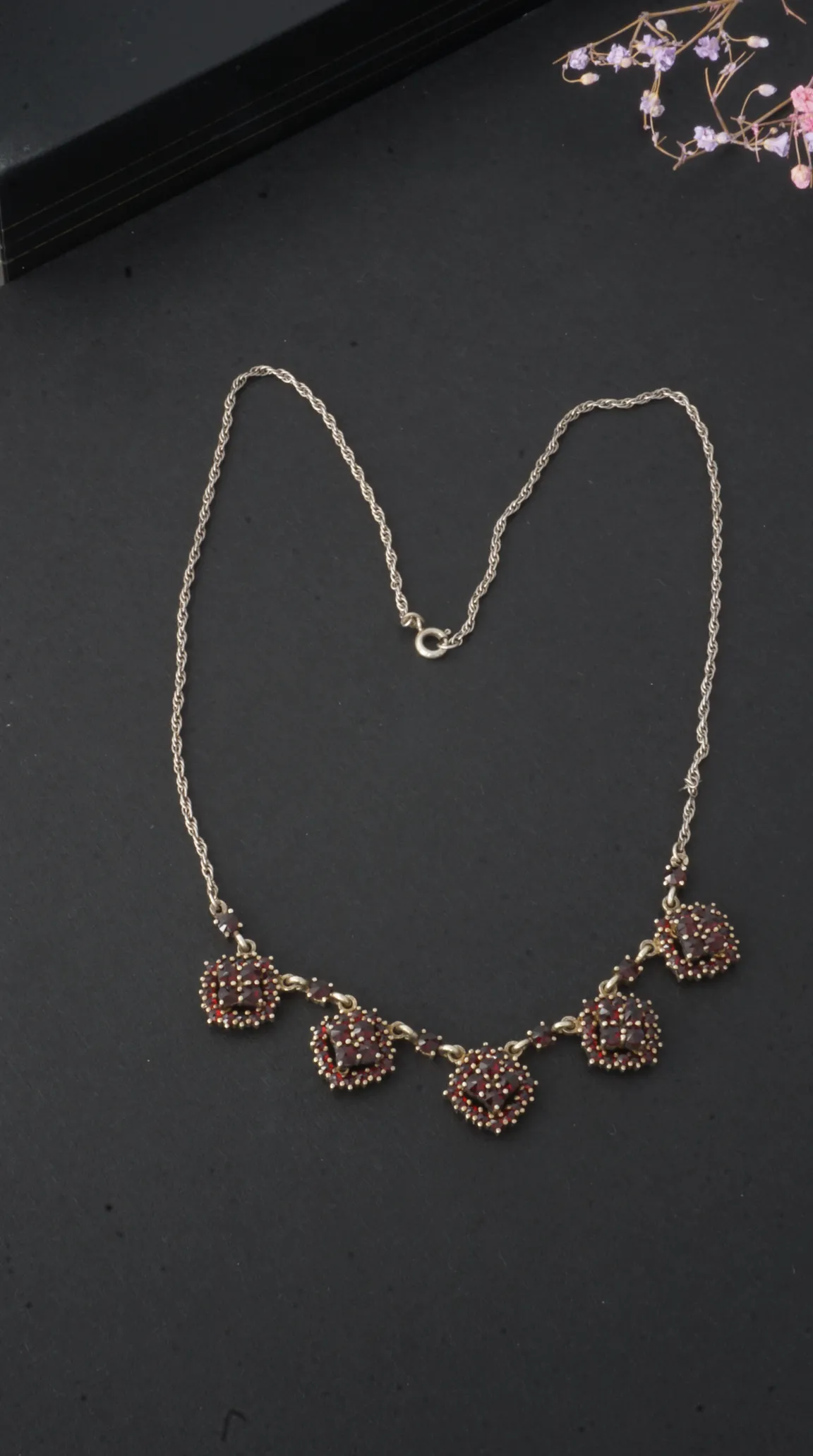 Vintage garnet cluster necklace with silver-tone rope chain and ornate gold-tone settings.