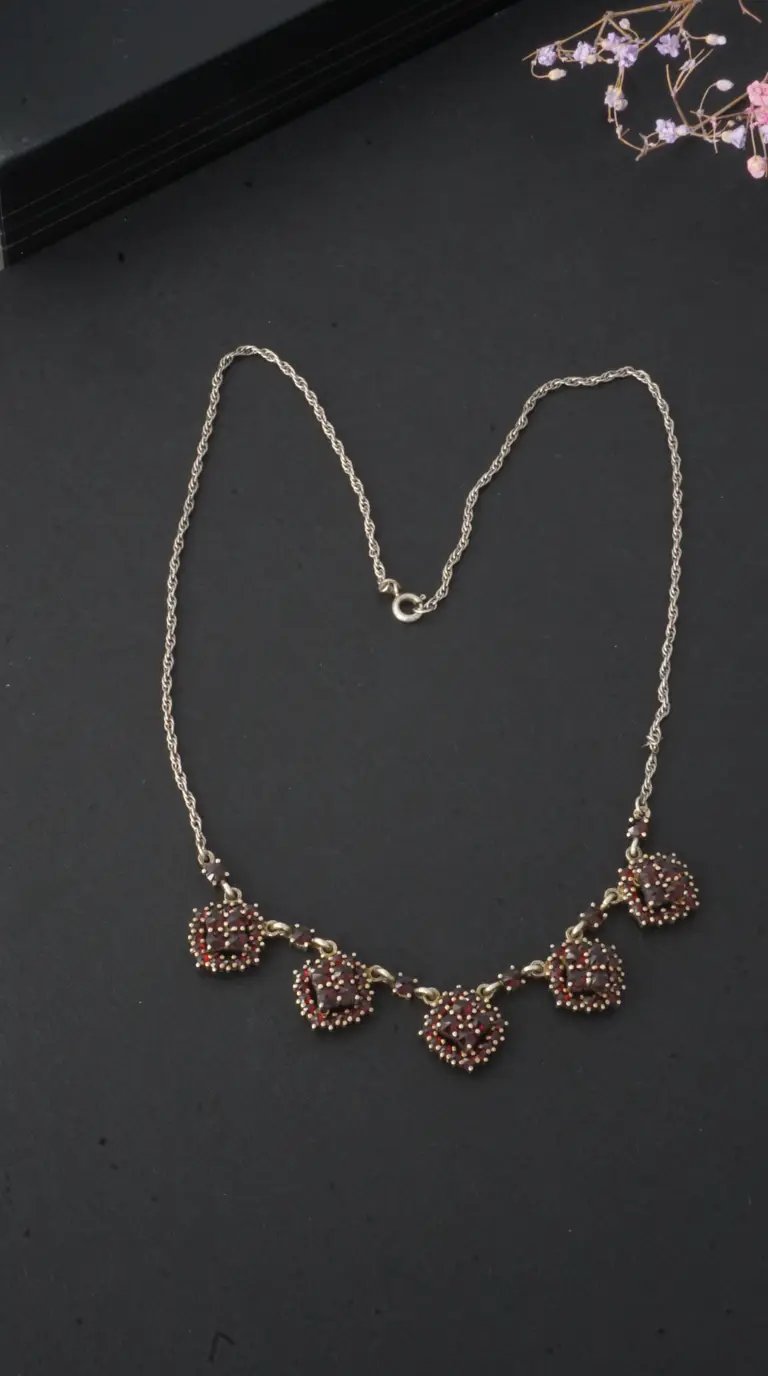 Vintage garnet cluster necklace with silver-tone rope chain and ornate gold-tone settings.