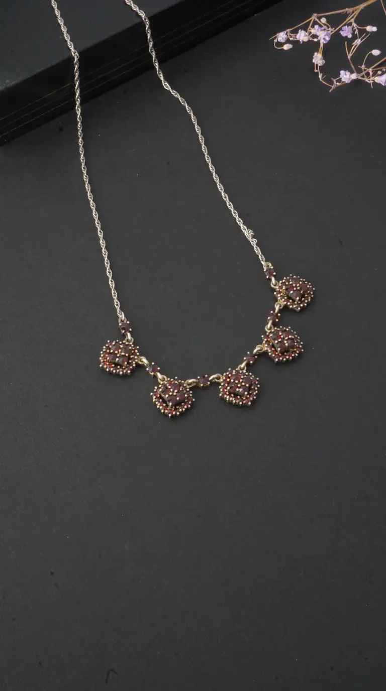 Vintage Bohemian garnet necklace with sterling silver rope chain and gold-tone clustered red gemstone settings.