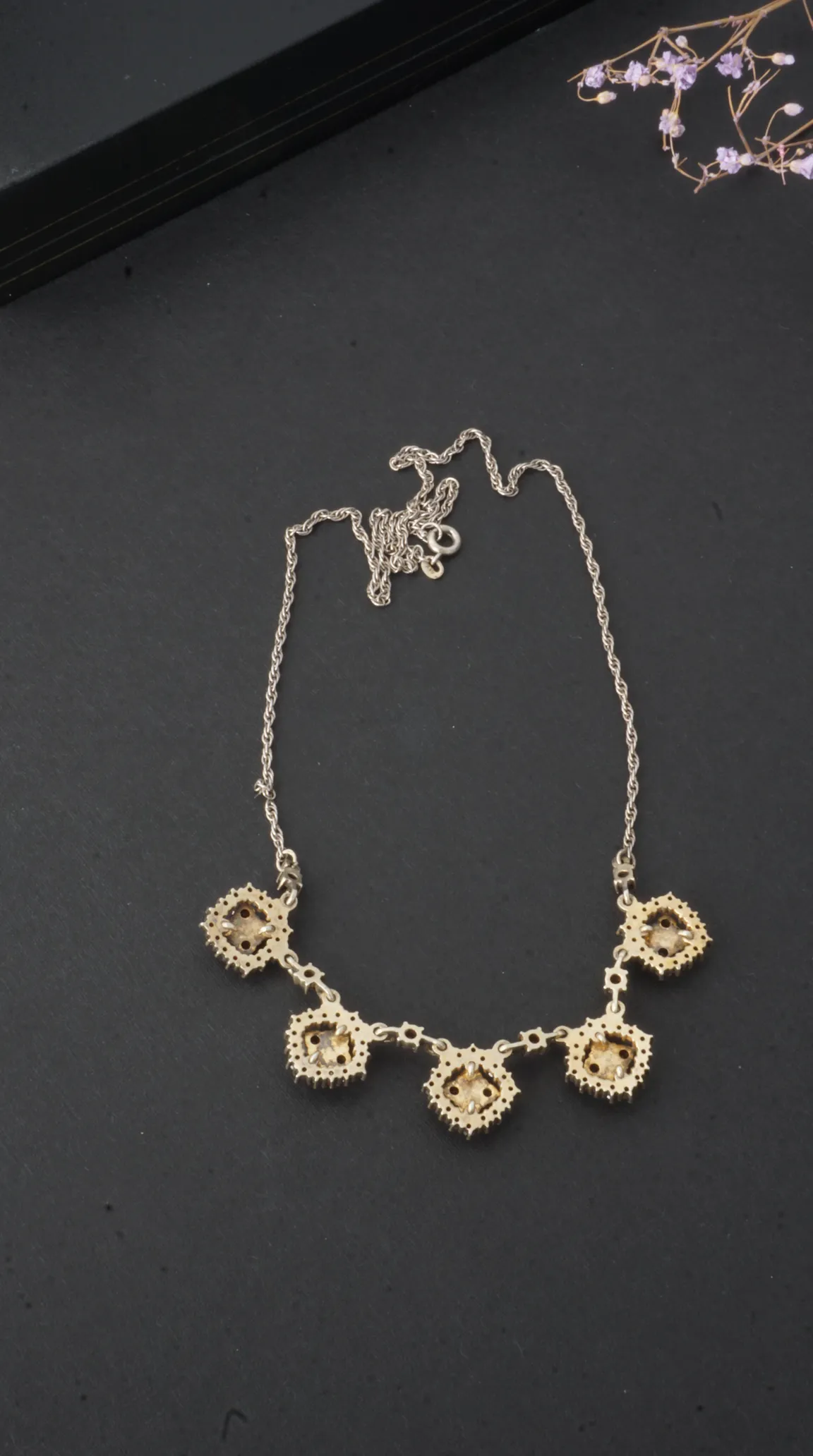 Vintage silver rope chain necklace with five square gold-tone pendants set with light brown gemstones and clear crystals.