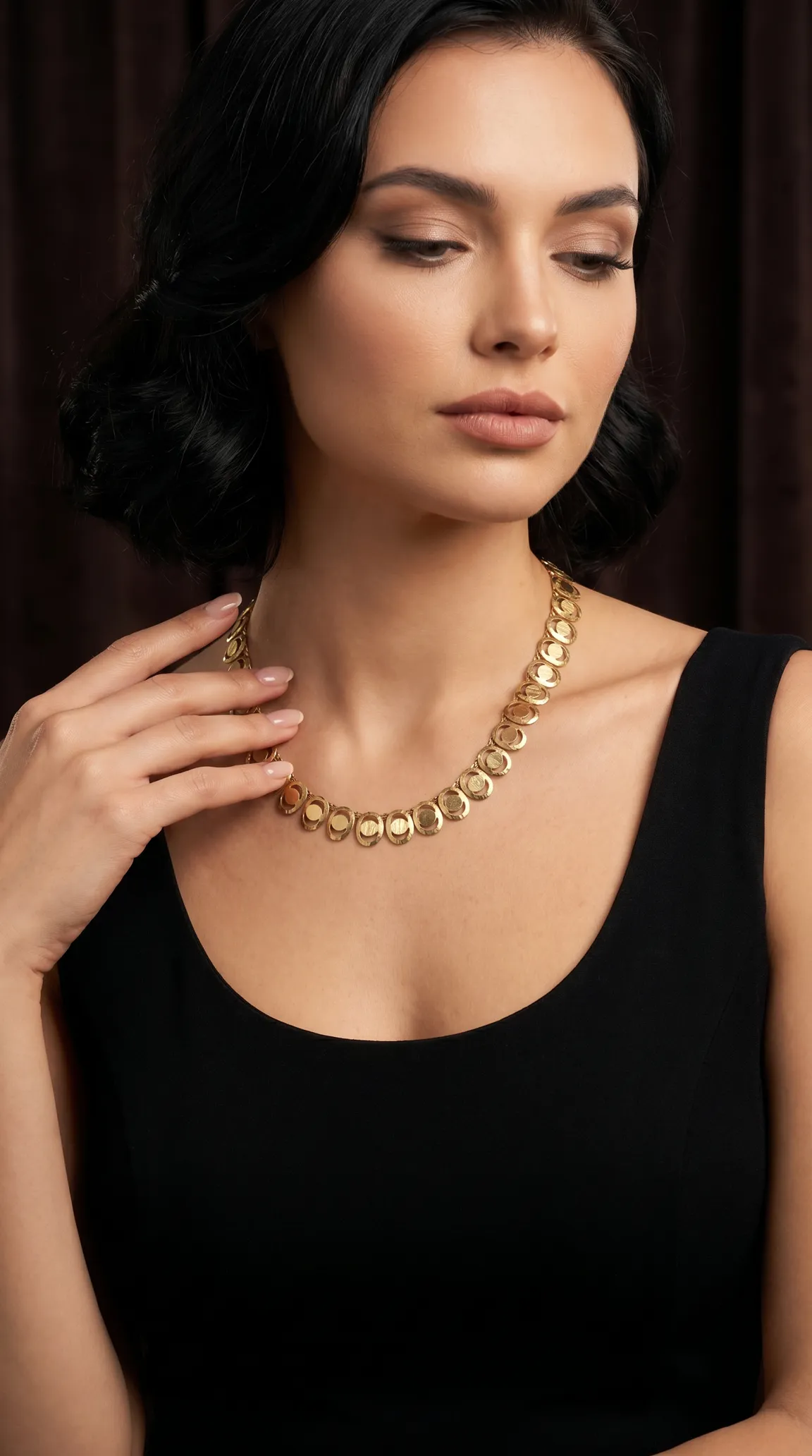 Vintage gold disc necklace with textured circular links on a woman's neck.