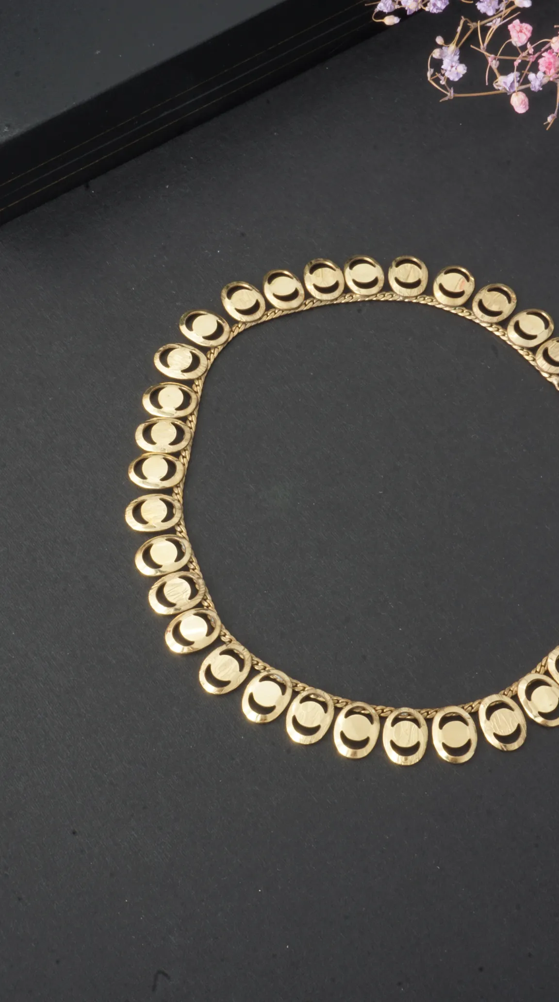 Vintage gold tone chunky necklace with unique oval links featuring crescent cutouts.