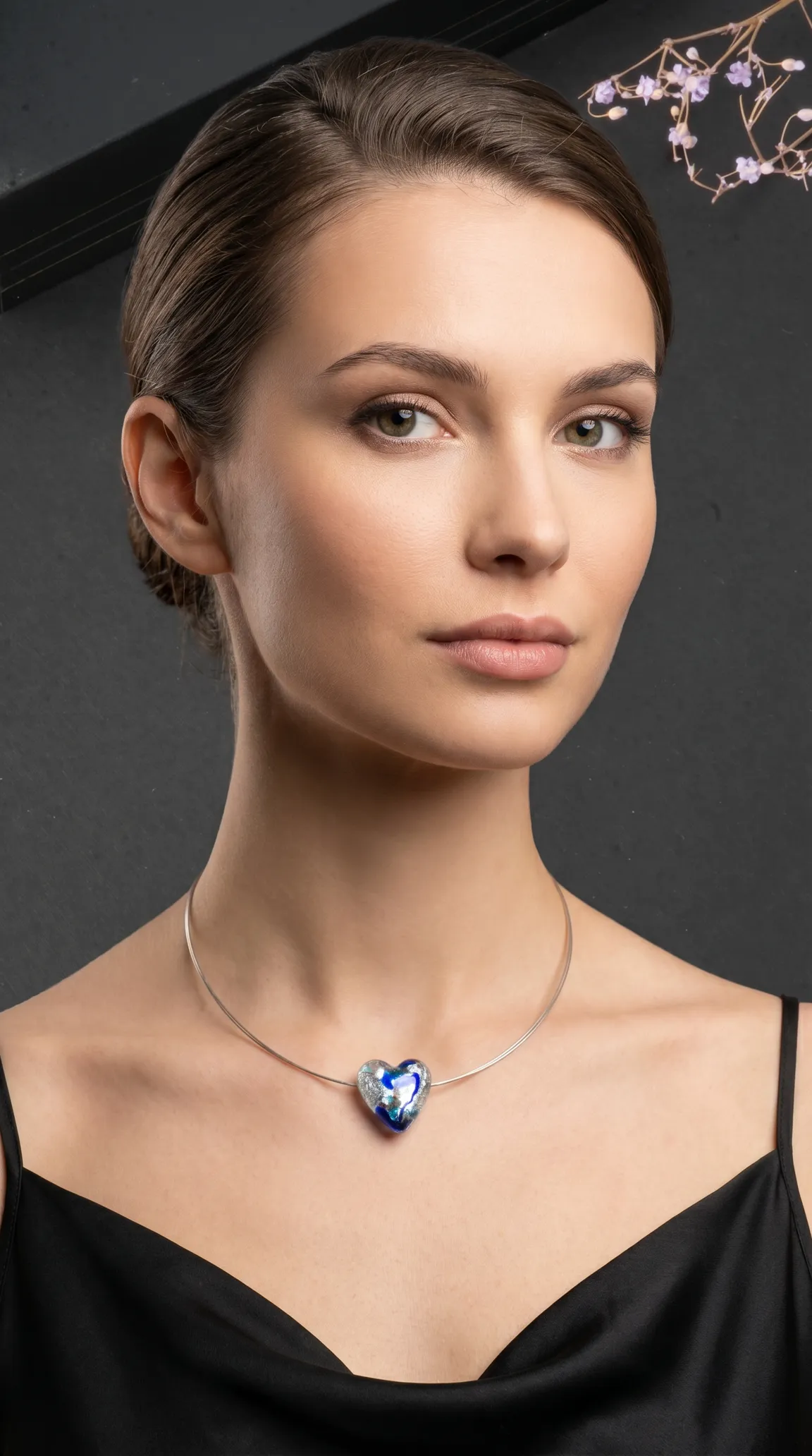 Vintage silver choker necklace with blue and silver art glass heart pendant on a woman.
