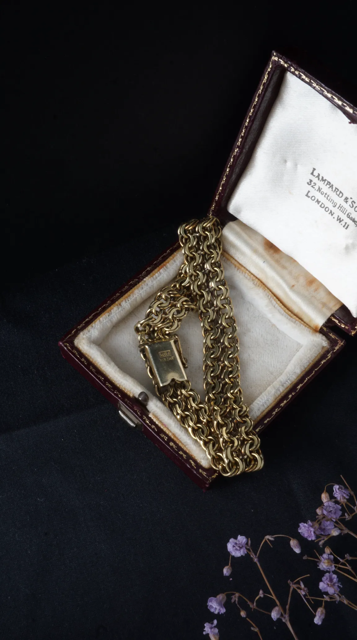 Vintage gold flat link bracelet in antique burgundy jewelry box from Lampard & Son London.