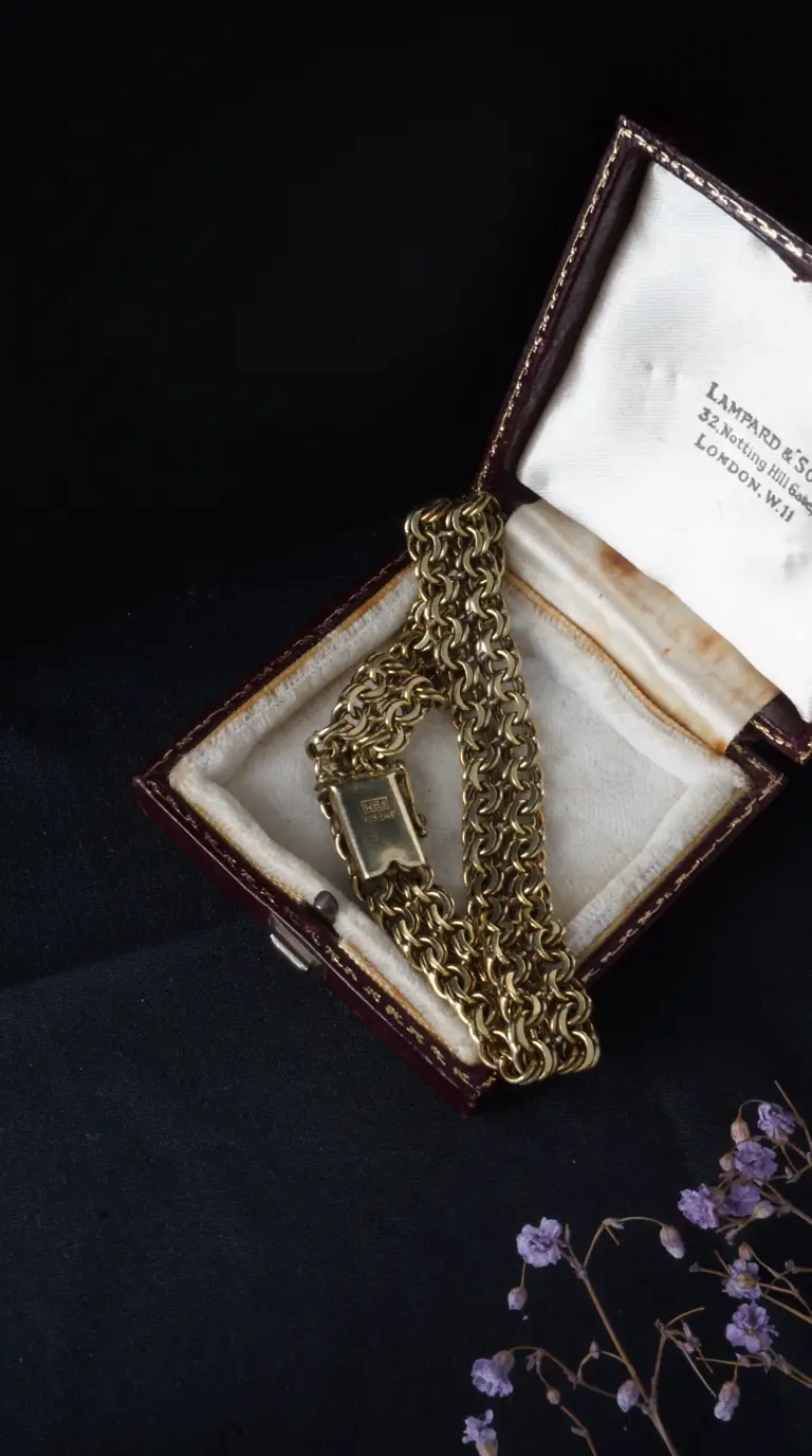 Vintage gold flat link bracelet in antique burgundy jewelry box from Lampard & Son London.