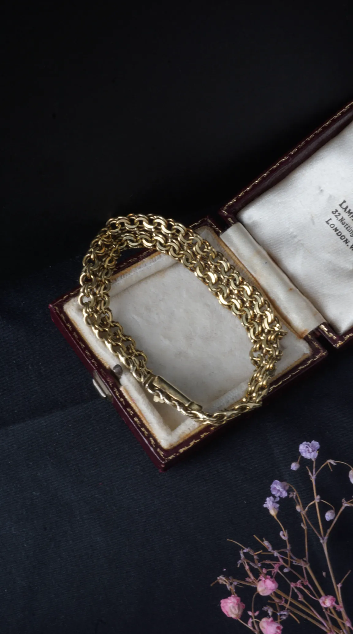 Vintage gold double rolo chain bracelet in antique burgundy leather jewelry box with cream lining