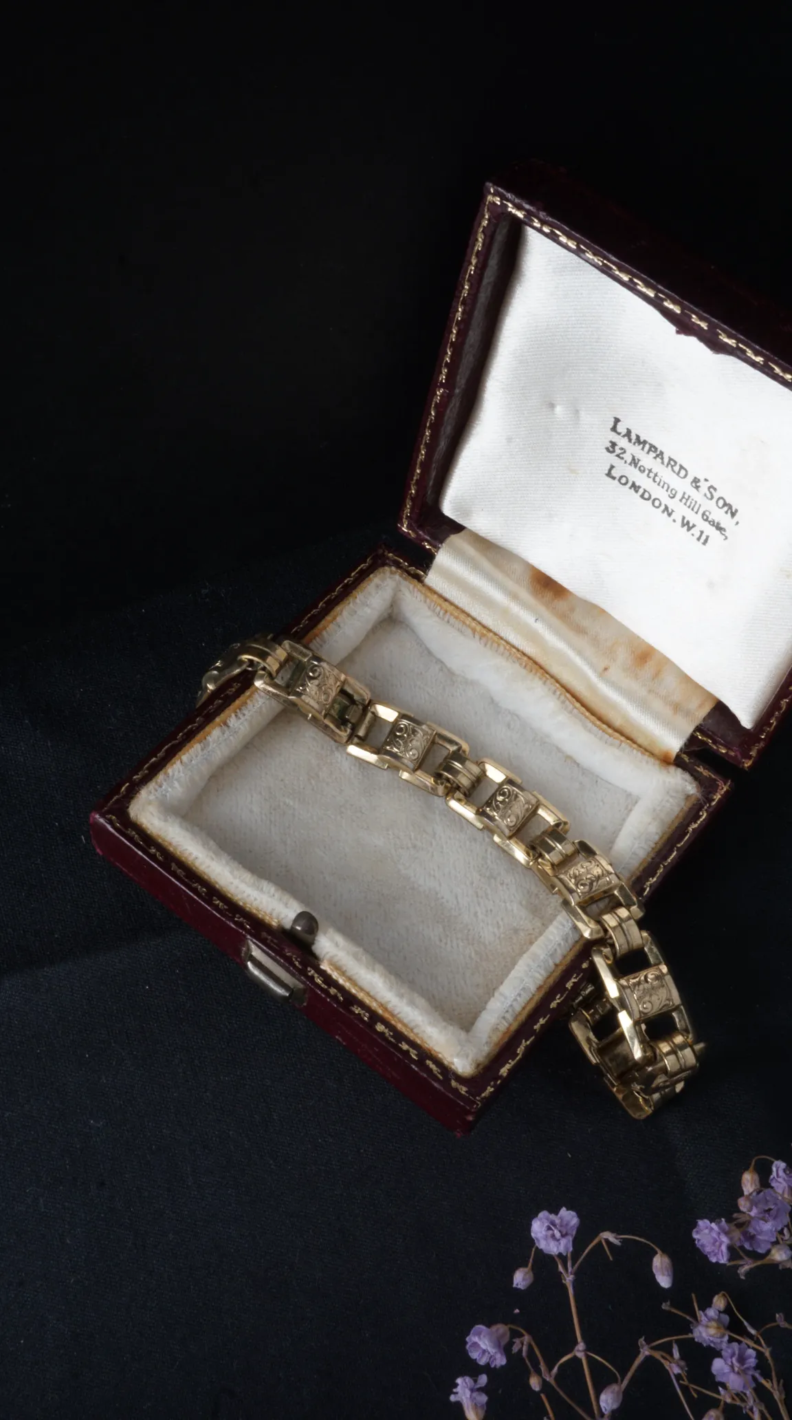 Vintage yellow gold engraved link bracelet in open antique burgundy jewelry box with white satin lining, Lampard & Son, Notting Hill Gate, London inscription.