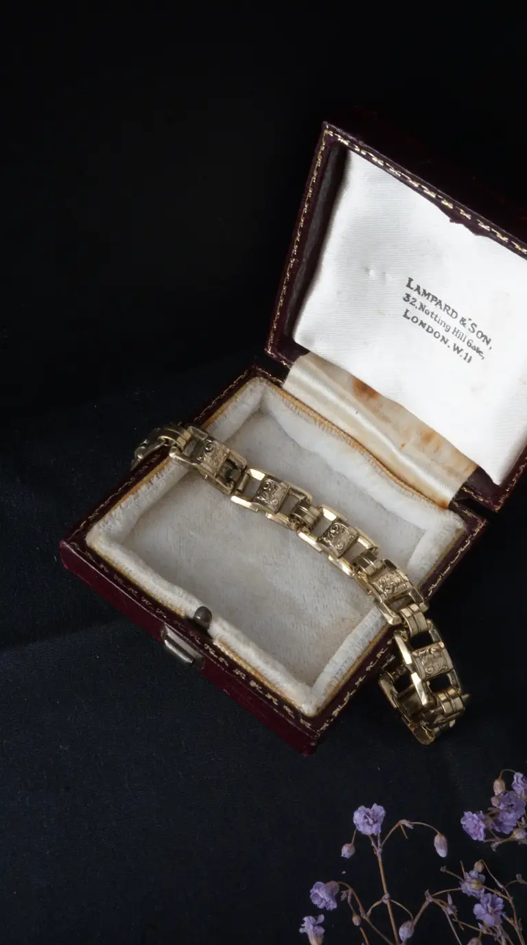 Vintage yellow gold engraved link bracelet in open antique burgundy jewelry box with white satin lining, Lampard & Son, Notting Hill Gate, London inscription.