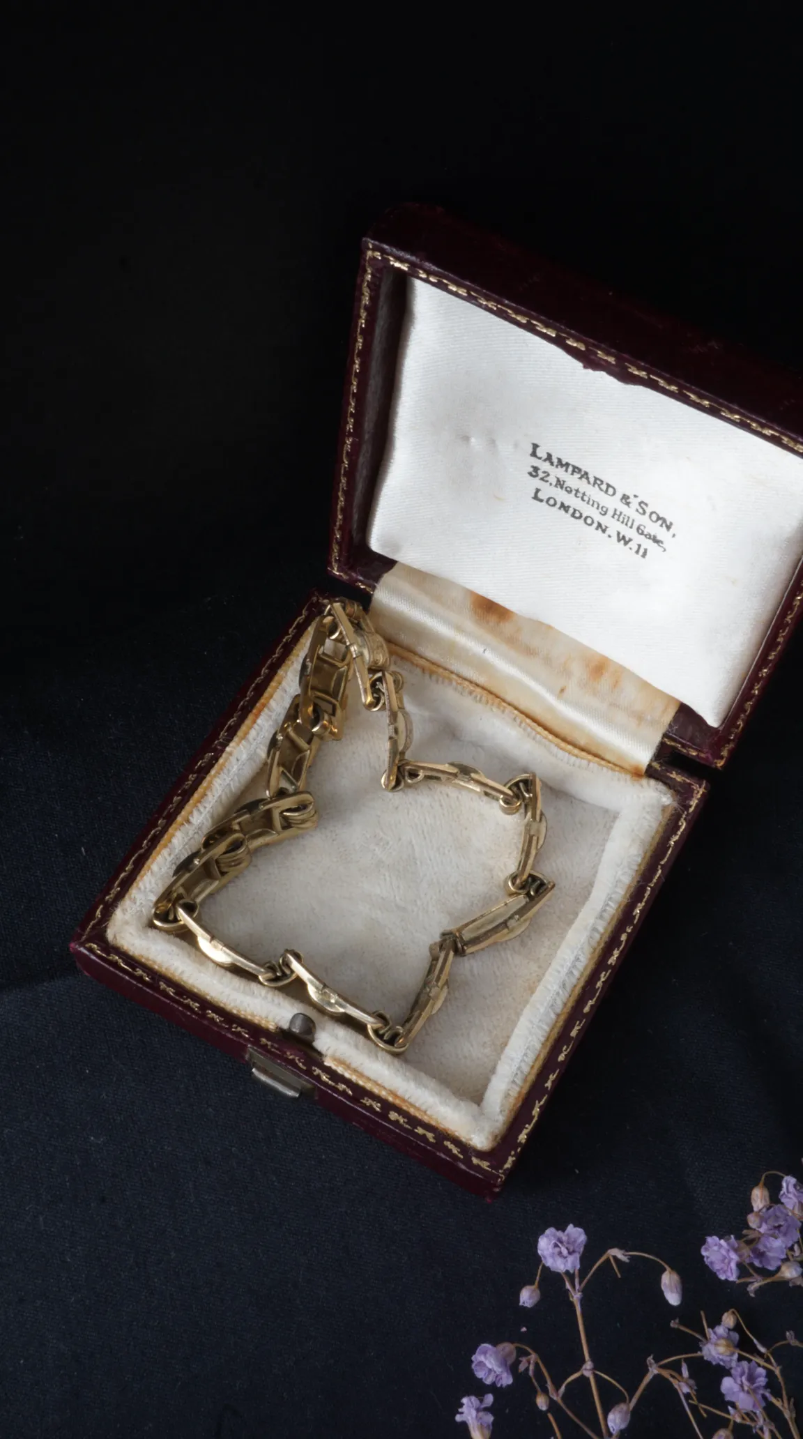 Vintage gold link bracelet in open antique red Lampard & Son jewelry box.
