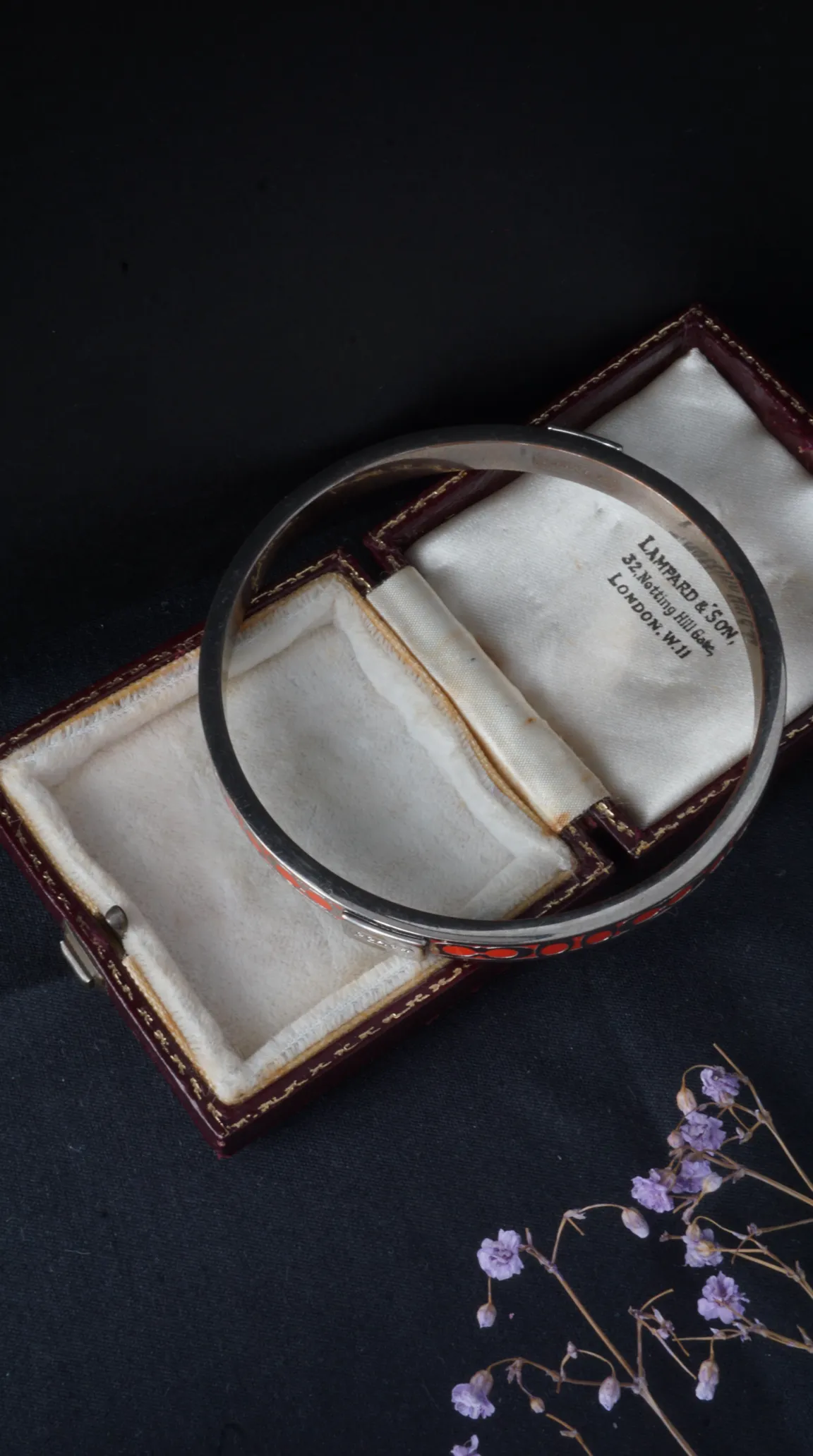Vintage silver enamel bangle bracelet with red and black geometric pattern, in antique Lampard & Son London jewelry box.