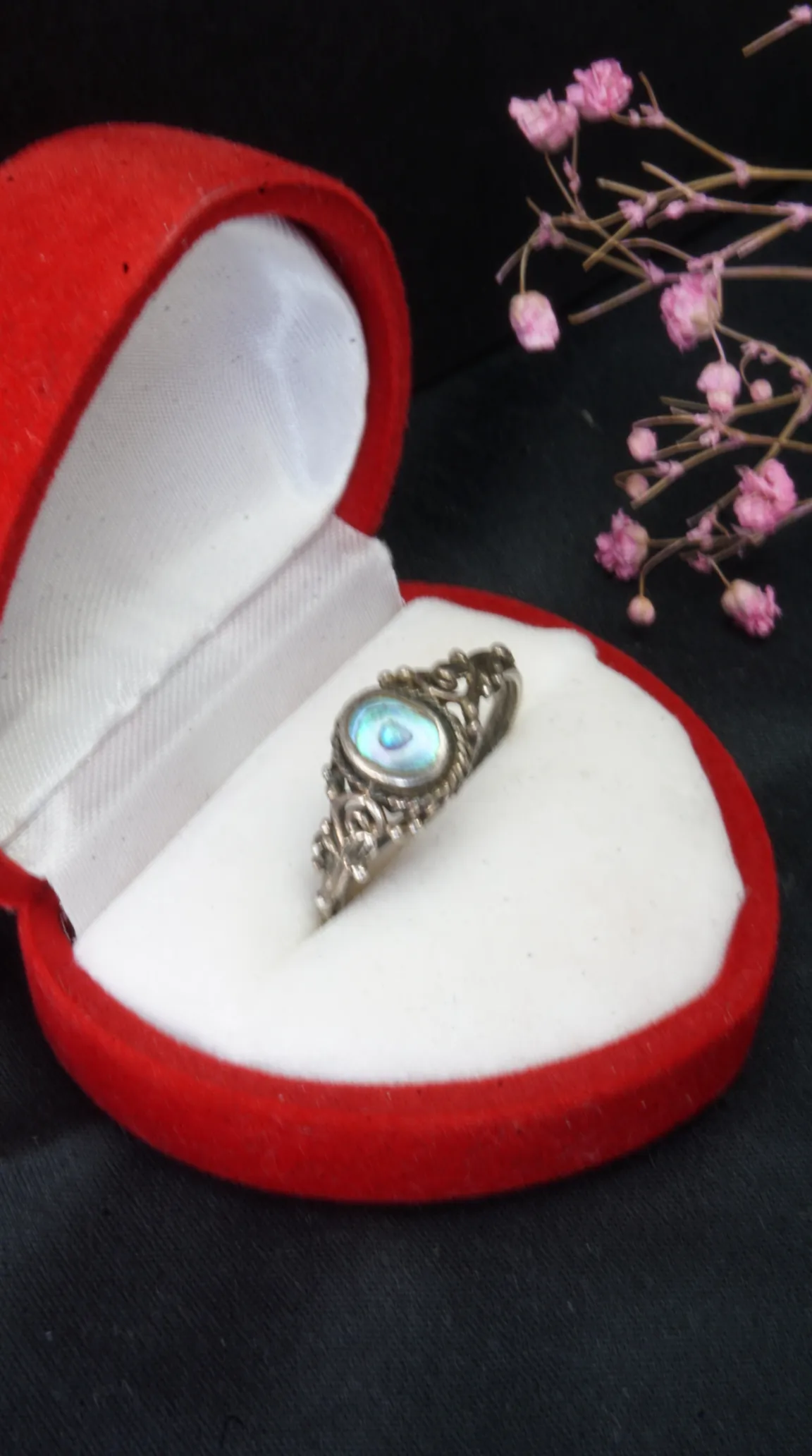 Vintage sterling silver filigree ring with iridescent abalone shell gemstone in red velvet jewelry box