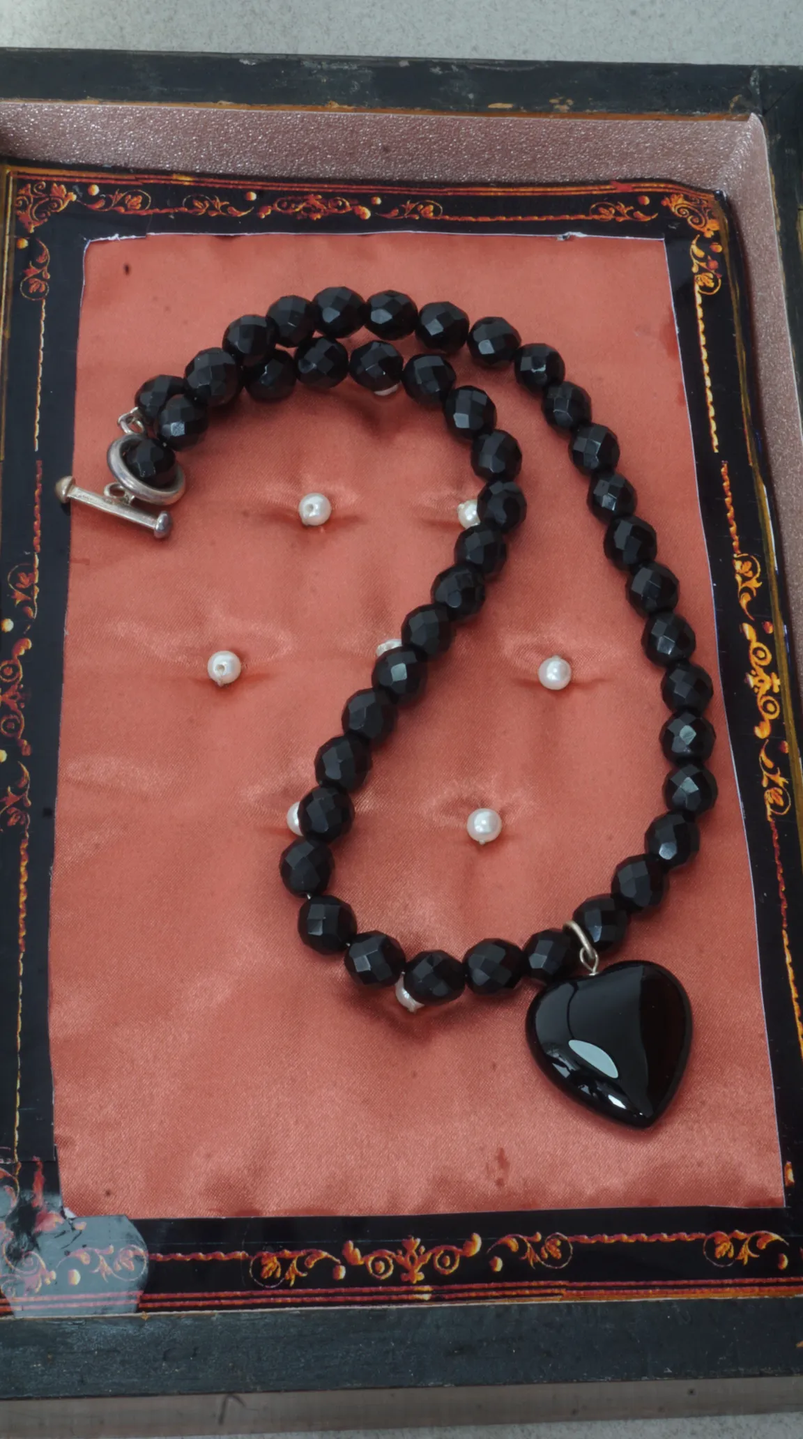 Vintage black faceted bead necklace with heart pendant, white pearls, and silver toggle clasp