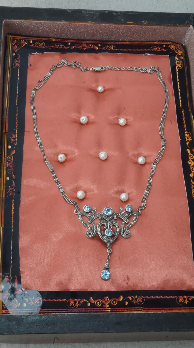 Vintage sterling silver ornate necklace with marcasite and blue gemstones on a multi-strand chain.