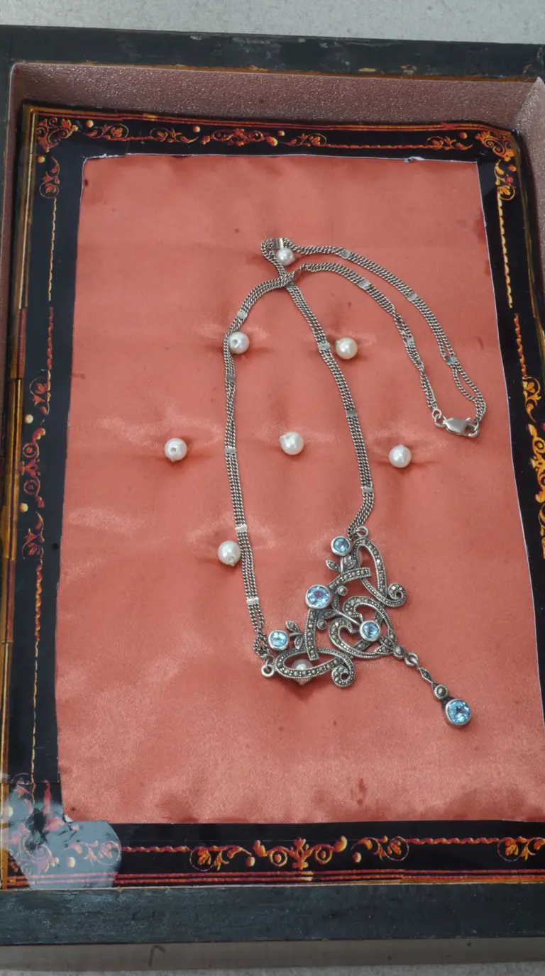 Vintage sterling silver marcasite blue topaz ornate pendant necklace with pearls on peach velvet