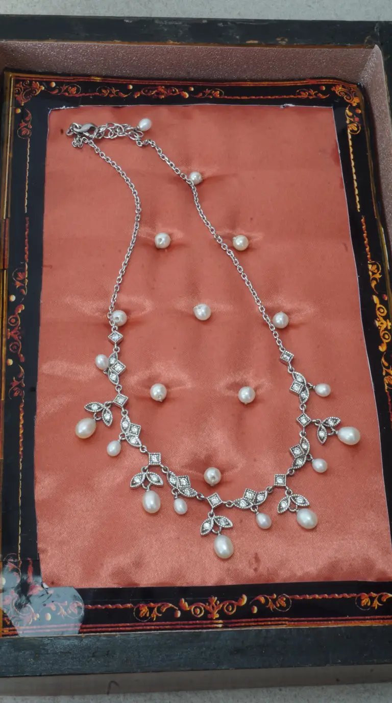Vintage sterling silver necklace with dangling freshwater pearls and sparkling rhinestone floral and geometric accents